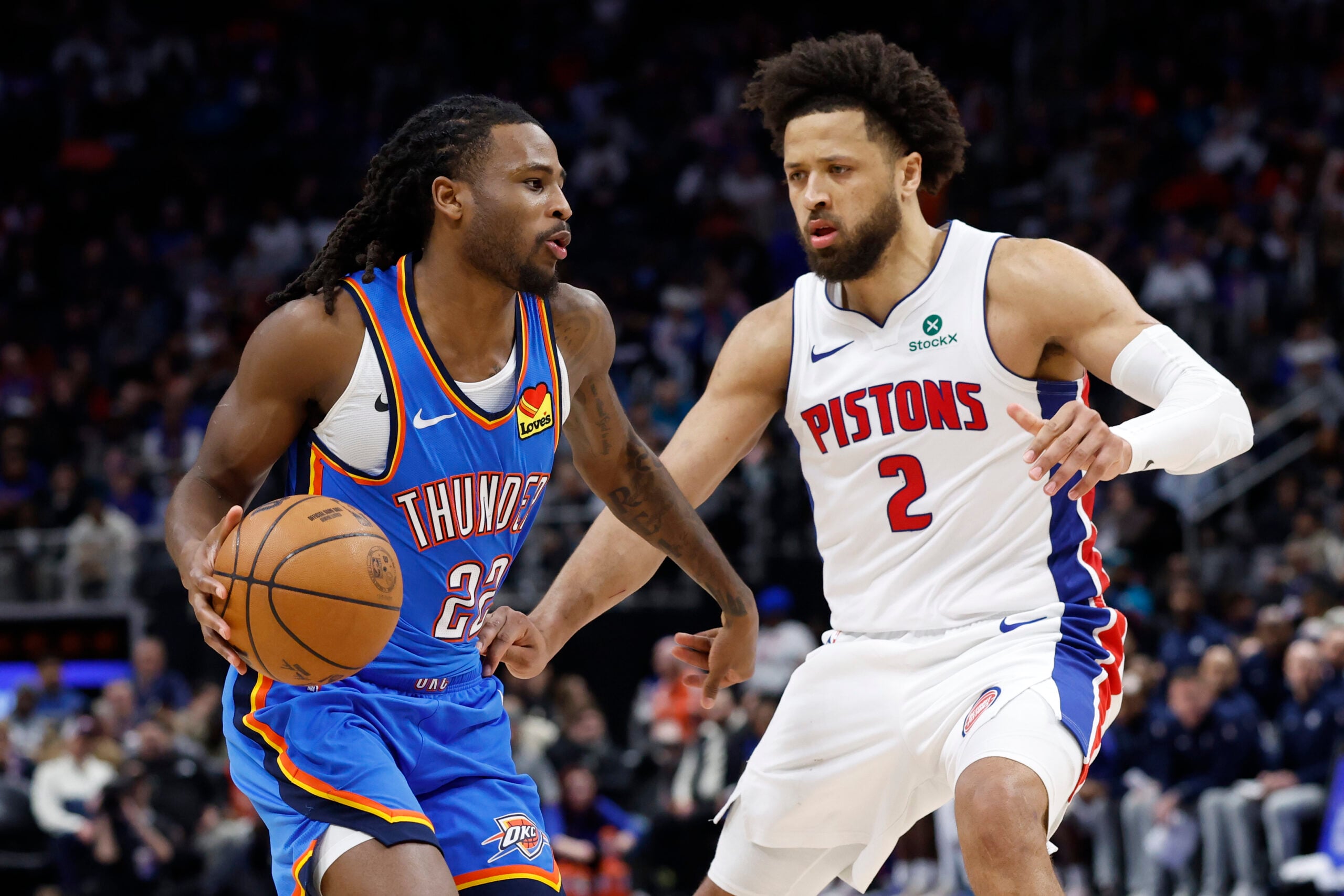 Feb 25, 2026; Detroit, Michigan, USA; Oklahoma City Thunder guard Cason Wallace (22) dribbles defended by Detroit Pistons guard Cade Cunningham (2) in the second half at Little Caesars Arena. Mandatory Credit: Rick Osentoski-Imagn Images
