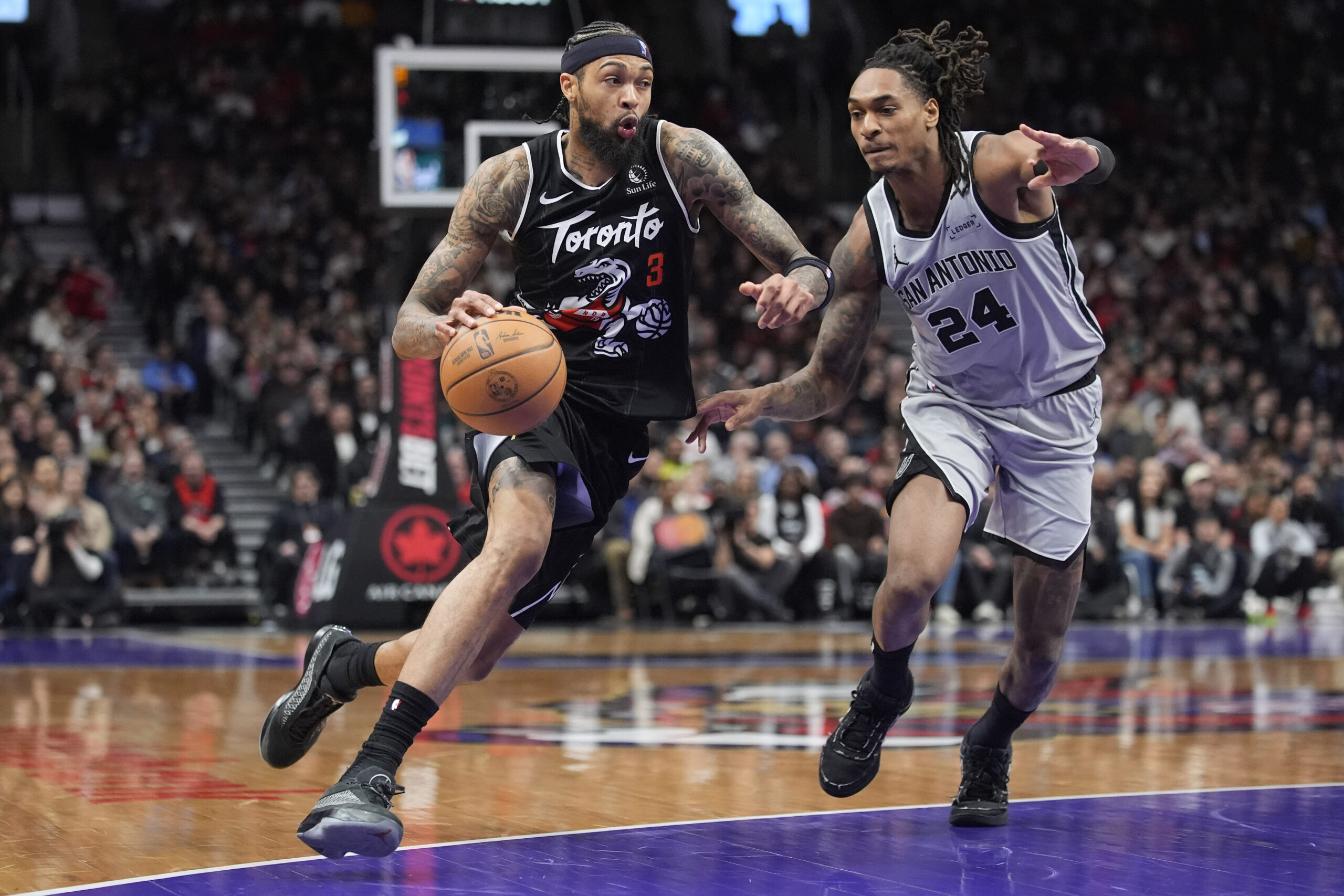 Feb 25, 2026; Toronto, Ontario, CAN; Toronto Raptors forward Brandon Ingram (3) drives to the basket against San Antonio Spurs guard Devin Vassell (24) during the second half at Scotiabank Arena. Mandatory Credit: John E. Sokolowski-Imagn Images