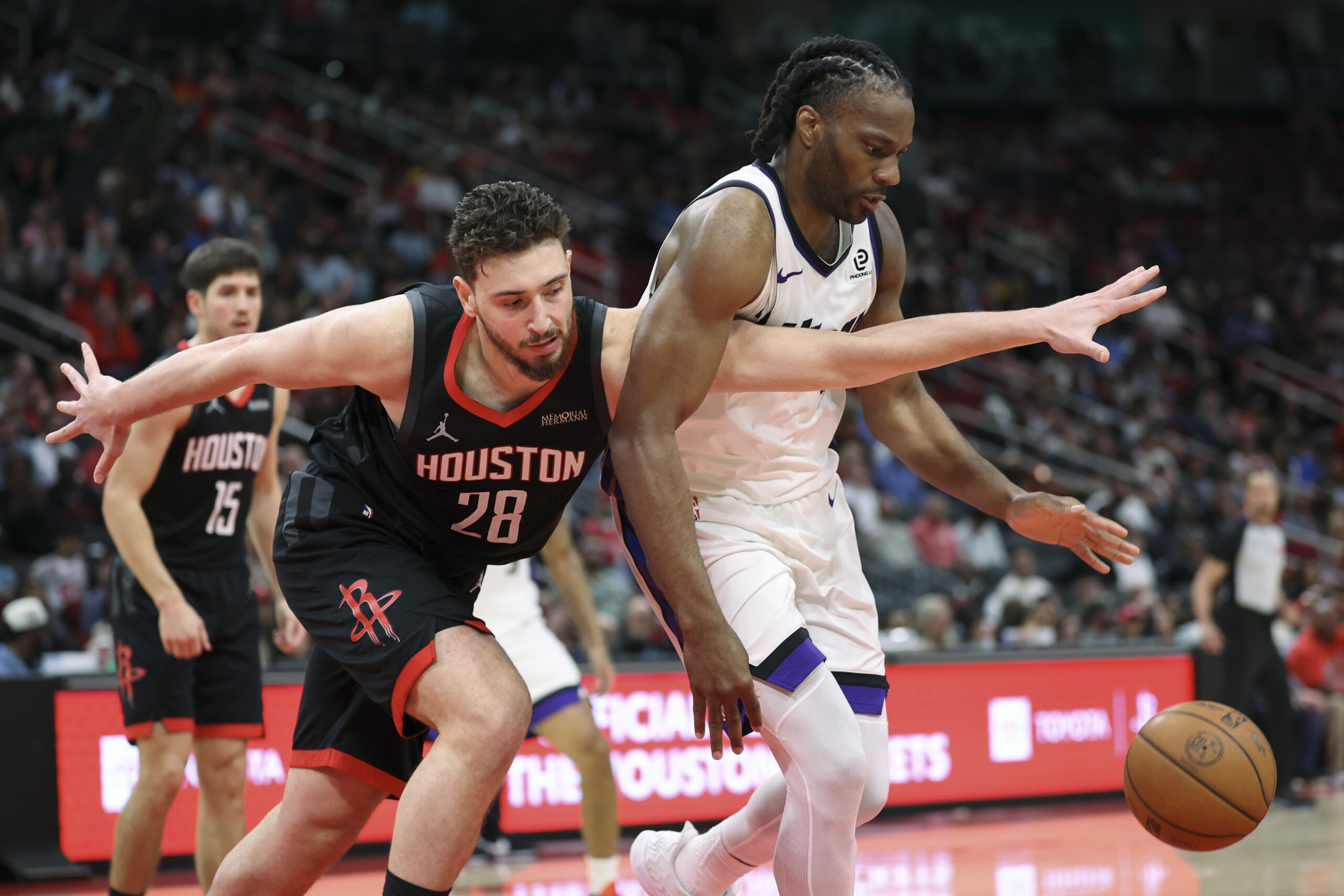 Feb 25, 2026; Houston, Texas, USA; Houston Rockets center Alperen Sengun (28) attempts to get control of the ball away from Sacramento Kings forward Precious Achiuwa (9) during the fourth quarter at Toyota Center. Mandatory Credit: Troy Taormina-Imagn Images