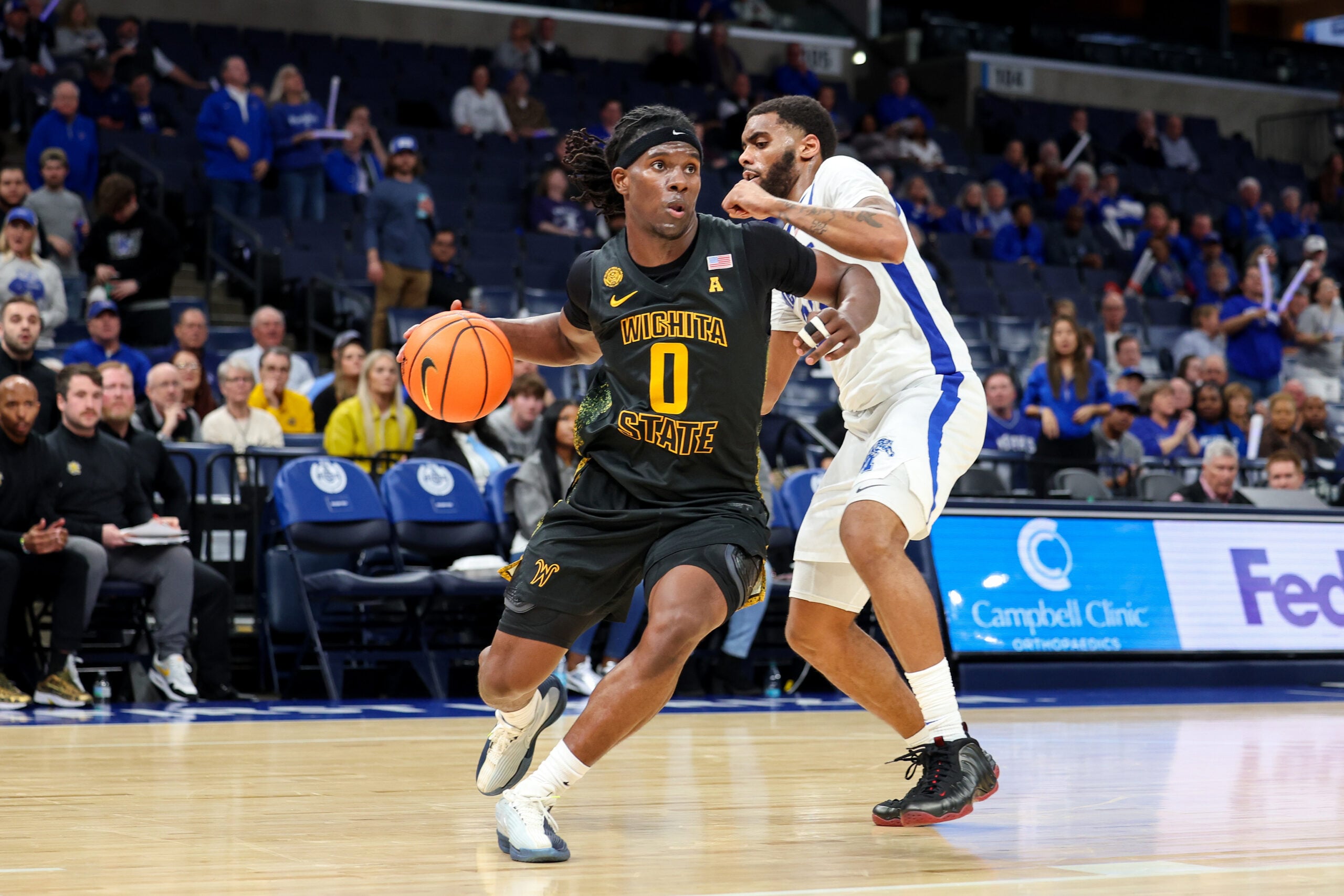 Feb 26, 2026; Memphis, Tennessee, USA; Wichita State Shockers forward Karon Boyd (0) drives to the basket against Memphis Tigers guard Sincere Parker (23) during the second half at FedExForum. Mandatory Credit: Wesley Hale-Imagn Images
