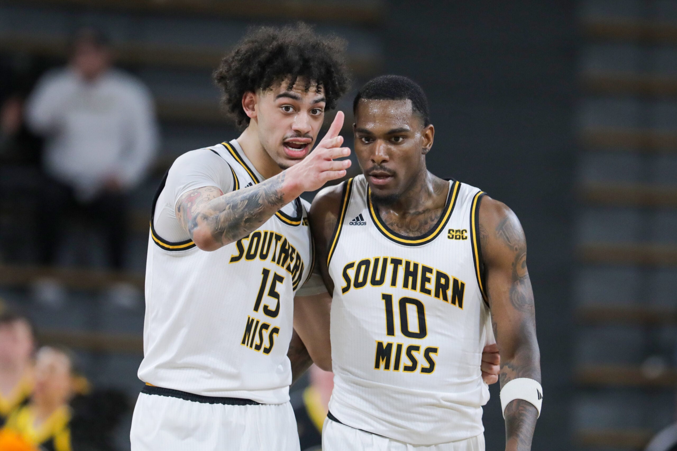 Jan 6, 2024; Hattiesburg, Mississippi, USA; Southern Miss Golden Eagles guard Donovan Ivory (15) talks to guard Cobie Montgomery (10) during the first half against the James Madison Dukes at Reed Green Coliseum. Mandatory Credit: Chuck Cook-Imagn Images