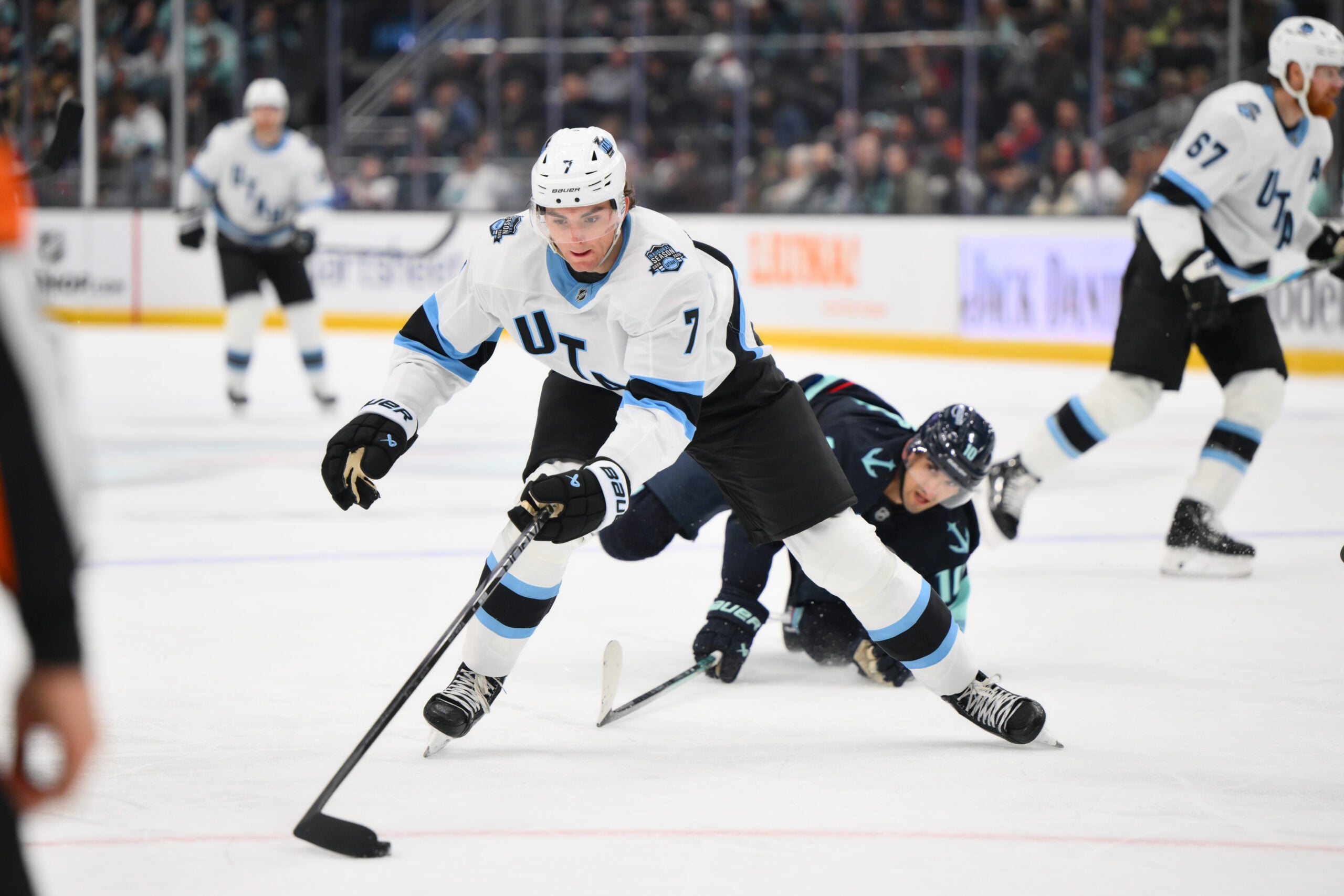 Mar 14, 2025; Seattle, Washington, USA; Utah Hockey Club defenseman Michael Kesselring (7) plays the puck during the second period against the Seattle Kraken at Climate Pledge Arena. Mandatory Credit: Steven Bisig-Imagn Images