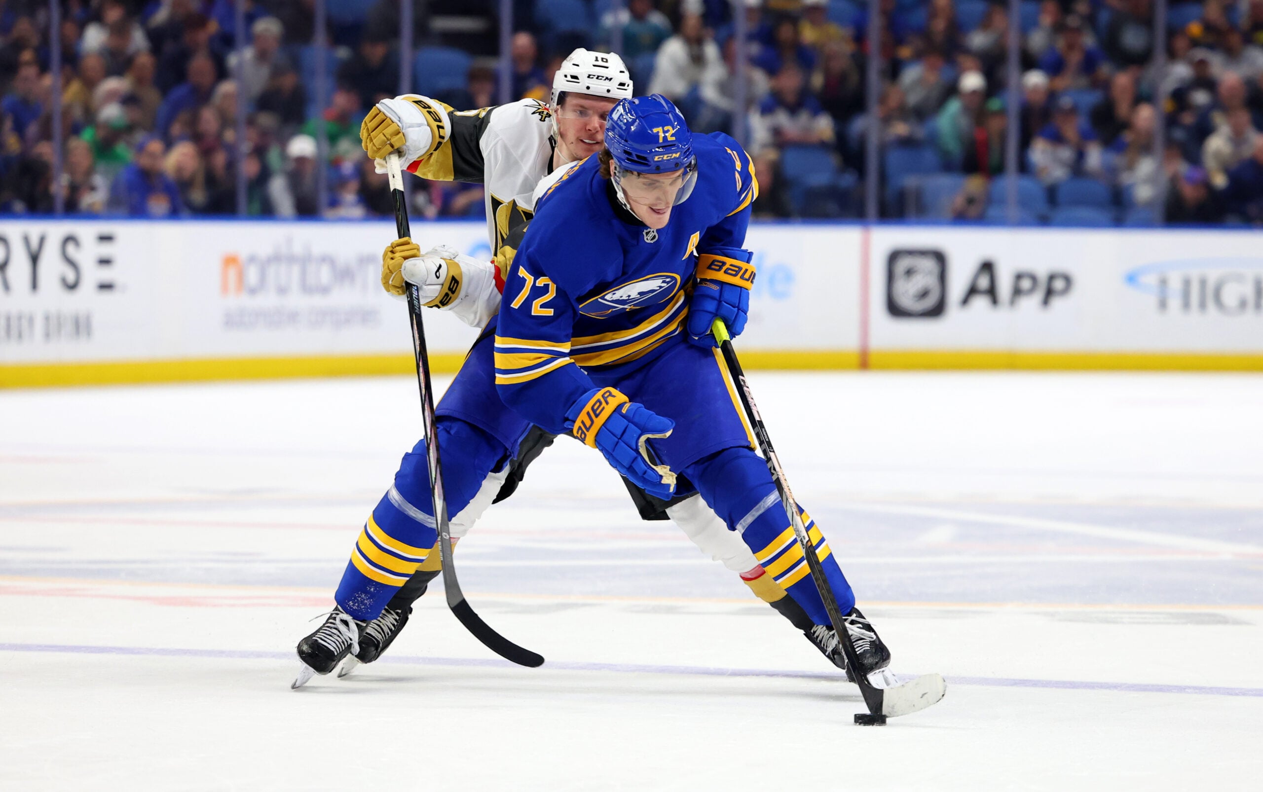 Mar 15, 2025; Buffalo, New York, USA; Buffalo Sabres center Tage Thompson (72) skates with the puck as Vegas Golden Knights left wing Pavel Dorofeyev (16) defends during overtime at KeyBank Center. Mandatory Credit: Timothy T. Ludwig-Imagn Images