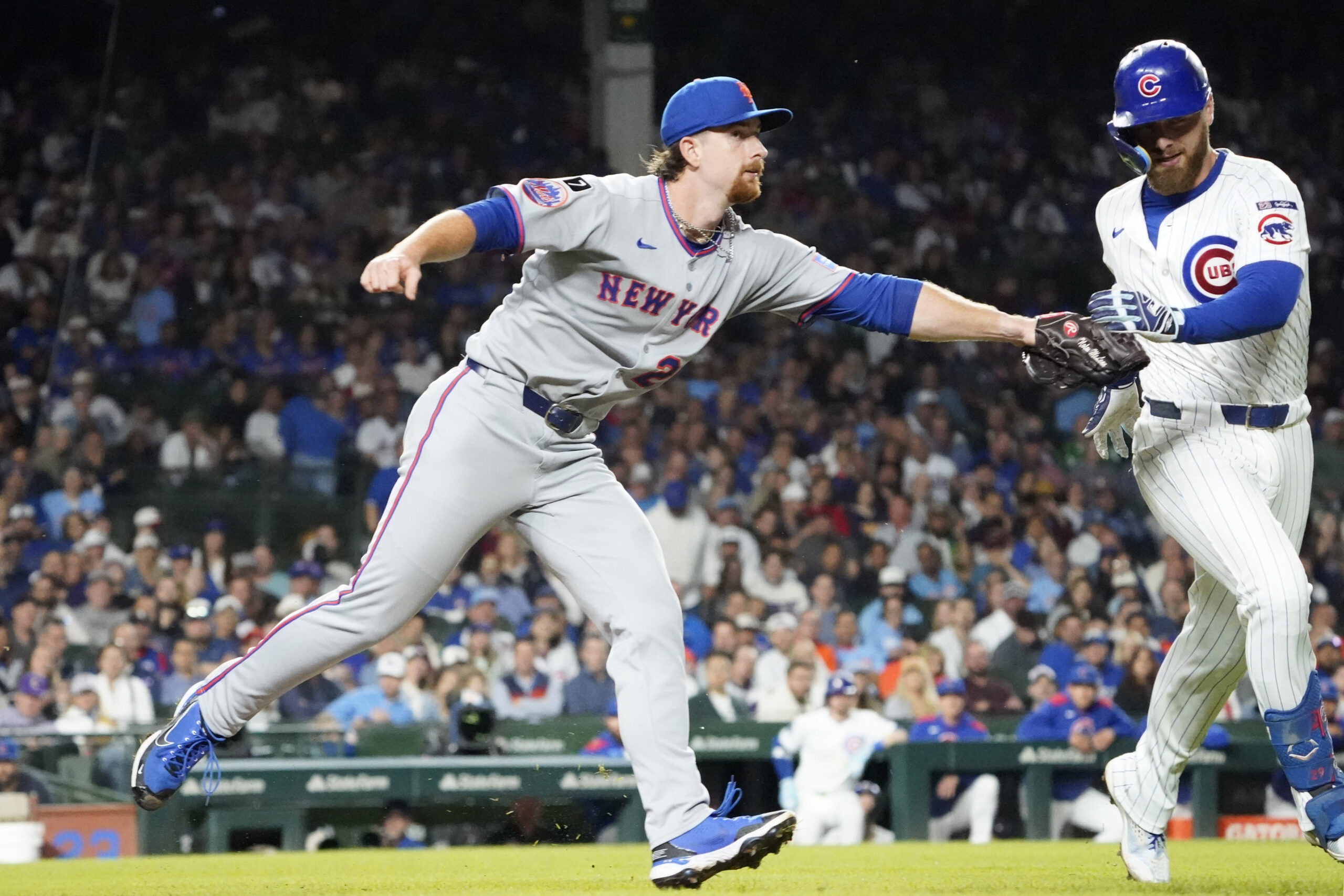Sep 25, 2025; Chicago, Illinois, USA; New York Mets pitcher Nolan McLean (26) tags out Chicago Cubs first base Michael Busch (29) during the fifth inning at Wrigley Field. Mandatory Credit: David Banks-Imagn Images