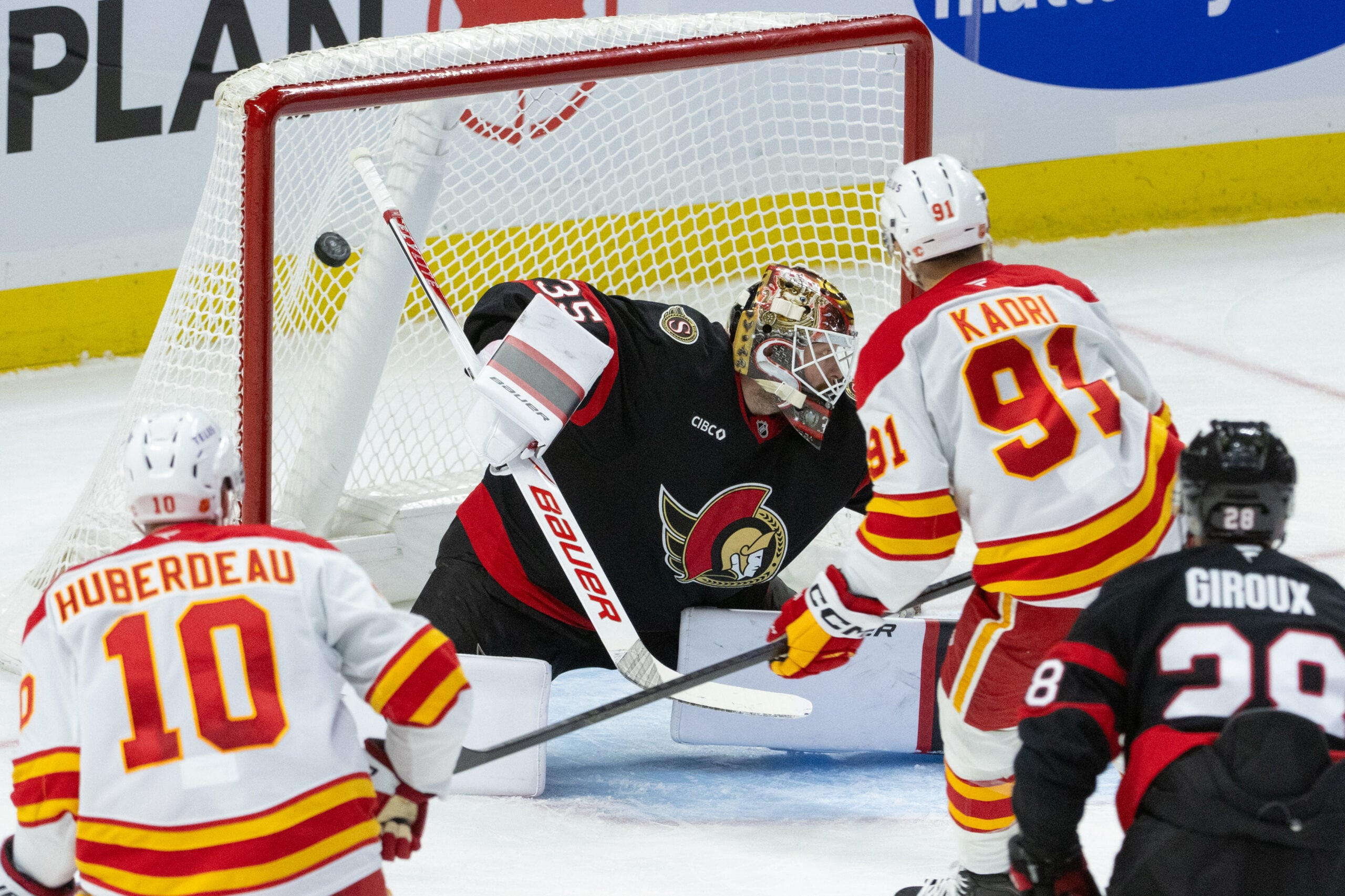 Oct 30, 2025; Ottawa, Ontario, CAN; Calgary Flames center Nazem Kadri (91) scores against Ottawa Senators goalie Linus Ullmark (35) in the third period at the Canadian Tire Centre. Mandatory Credit: Marc DesRosiers-IMAGN Images