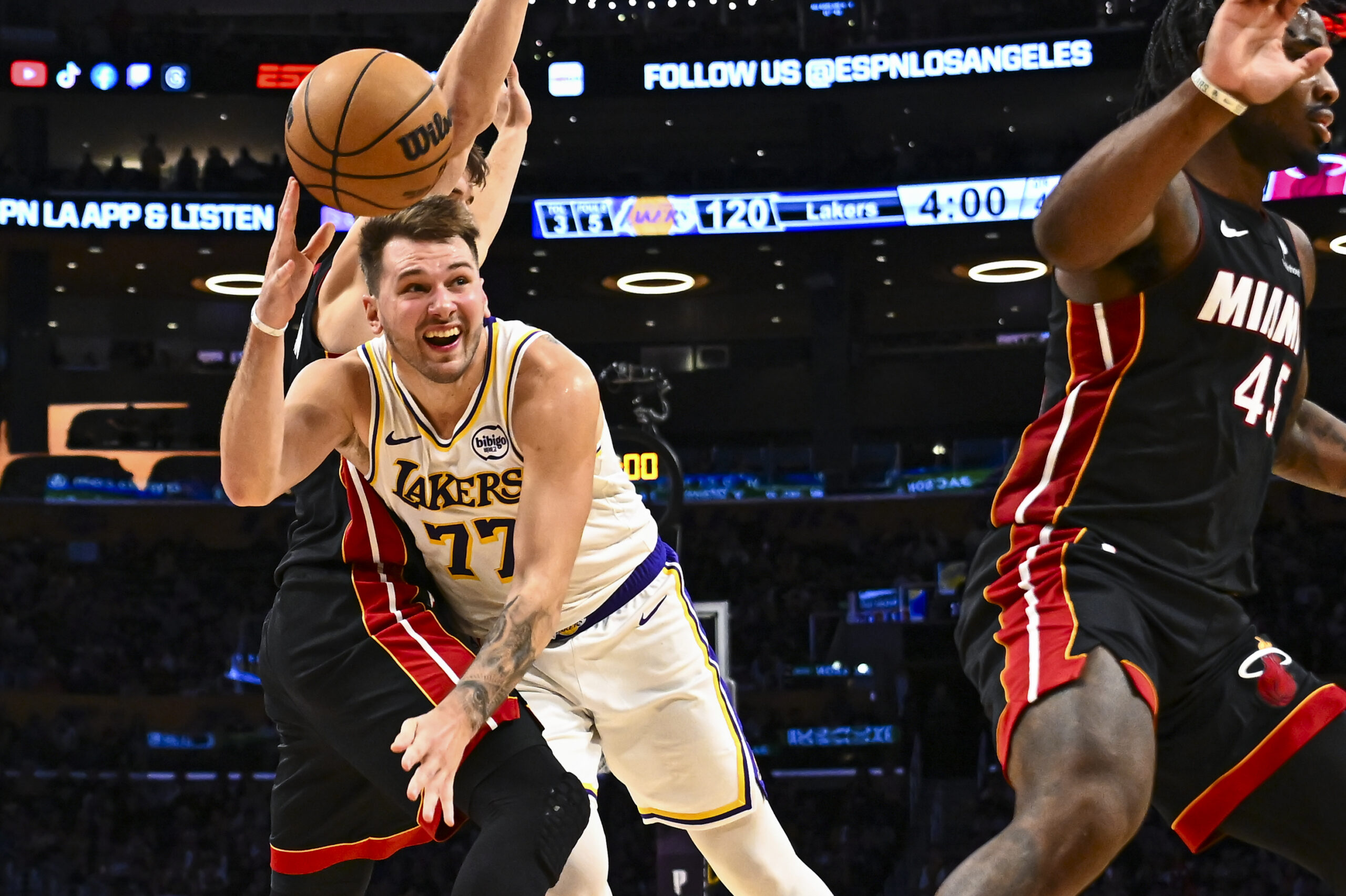 Nov 2, 2025; Los Angeles, California, USA; Los Angeles Lakers guard Luka Doncic (77) passes the ball against Miami Heat guard Pelle Larsson (9) during the second half at Crypto.com Arena. Mandatory Credit: Jonathan Hui-Imagn Images