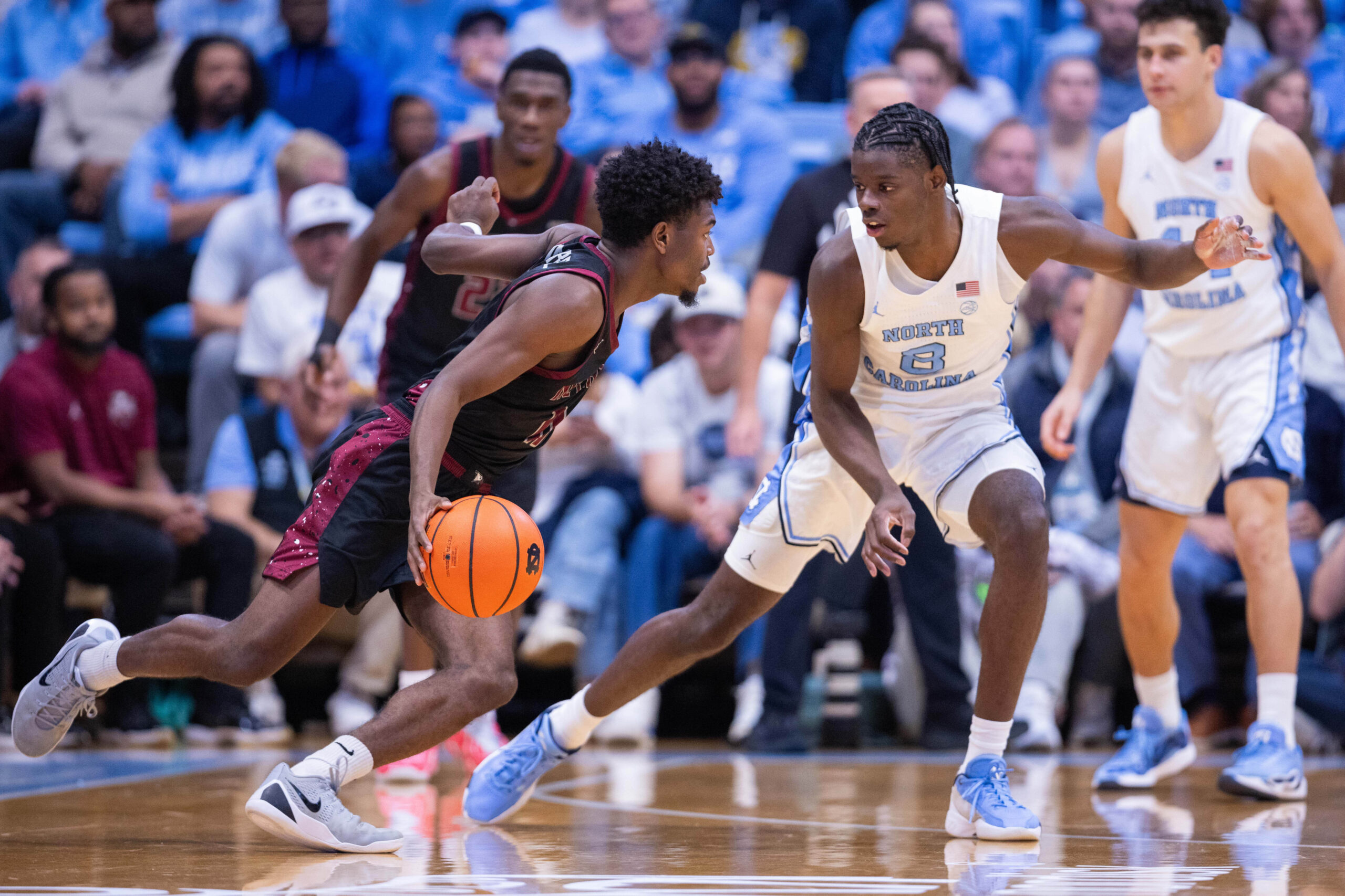 Nov 14, 2025; Chapel Hill, North Carolina, USA; North Carolina Tar Heels forward Caleb Wilson (8) guards North Carolina Central Eagles guard Gage Lattimore (11) during the second half at Dean E. Smith Center. Mandatory Credit: Scott Kinser-Imagn Images