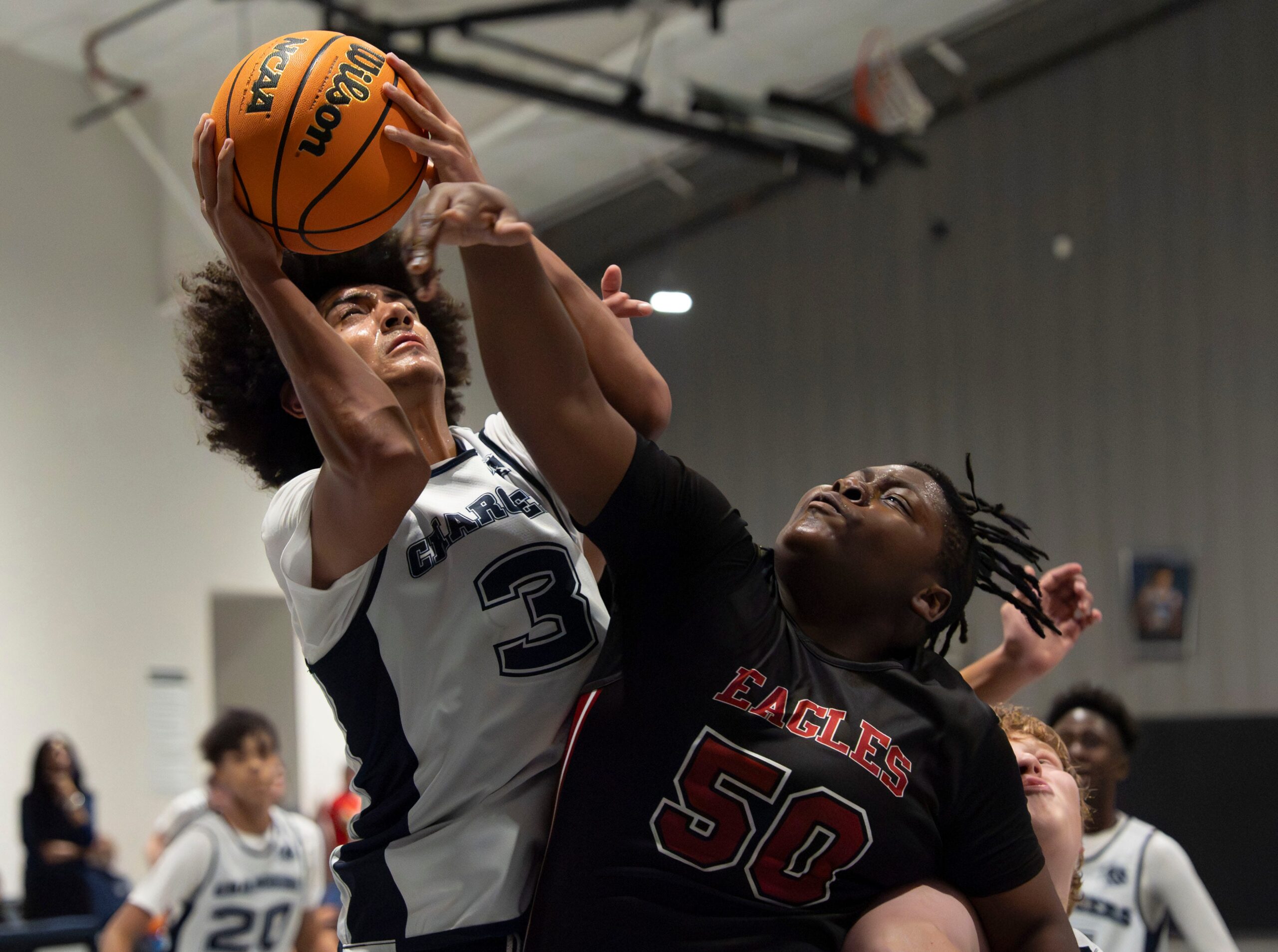 Nov 17, 2025; Northport, Alabama, USA; North River's Austin Harmon (3) battles for a shot agaisnt Victory Christian's Reben Skinner (50) at North River Christian Academy’s home gym at New Beginning Family Worship Center.