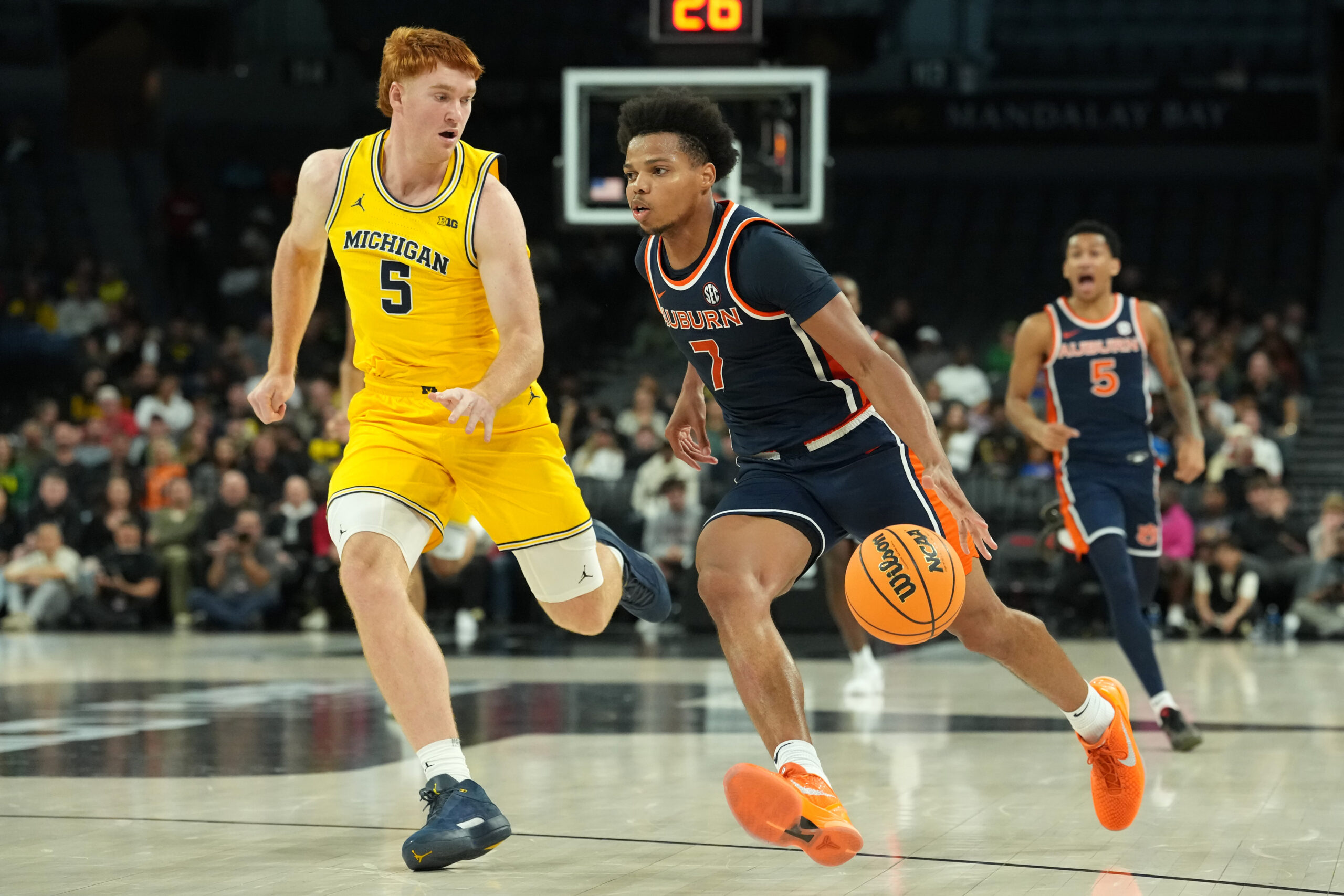 Nov 25, 2025; Las Vegas, NV, USA; Auburn Tigers guard Keyshawn Hall (7) drives to the basket against Michigan Wolverines forward Oscar Goodman (5) during the second half in a 2025 Players Era Festival group play game at Michelob ULTRA Arena. Mandatory Credit: Kirby Lee-Imagn Images