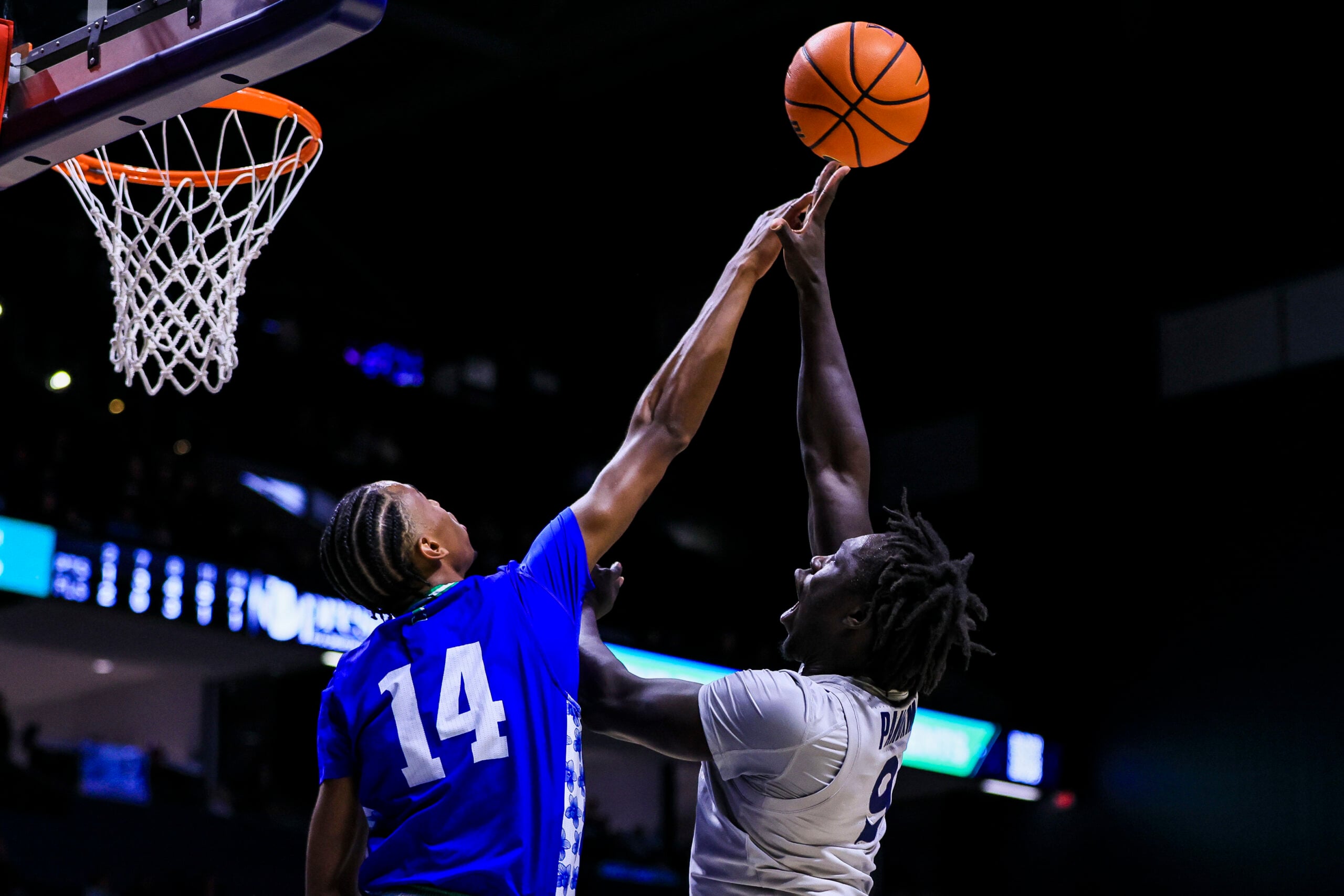 Nov 28, 2025; Cincinnati, Ohio, USA; Texas A&M-Corpus Christi Islanders guard Cedric Horton (14) blocks a shot by Xavier Musketeers guard Mier Panoam (9) in the second half at Cintas Center. Mandatory Credit: Katie Stratman-Imagn Images
