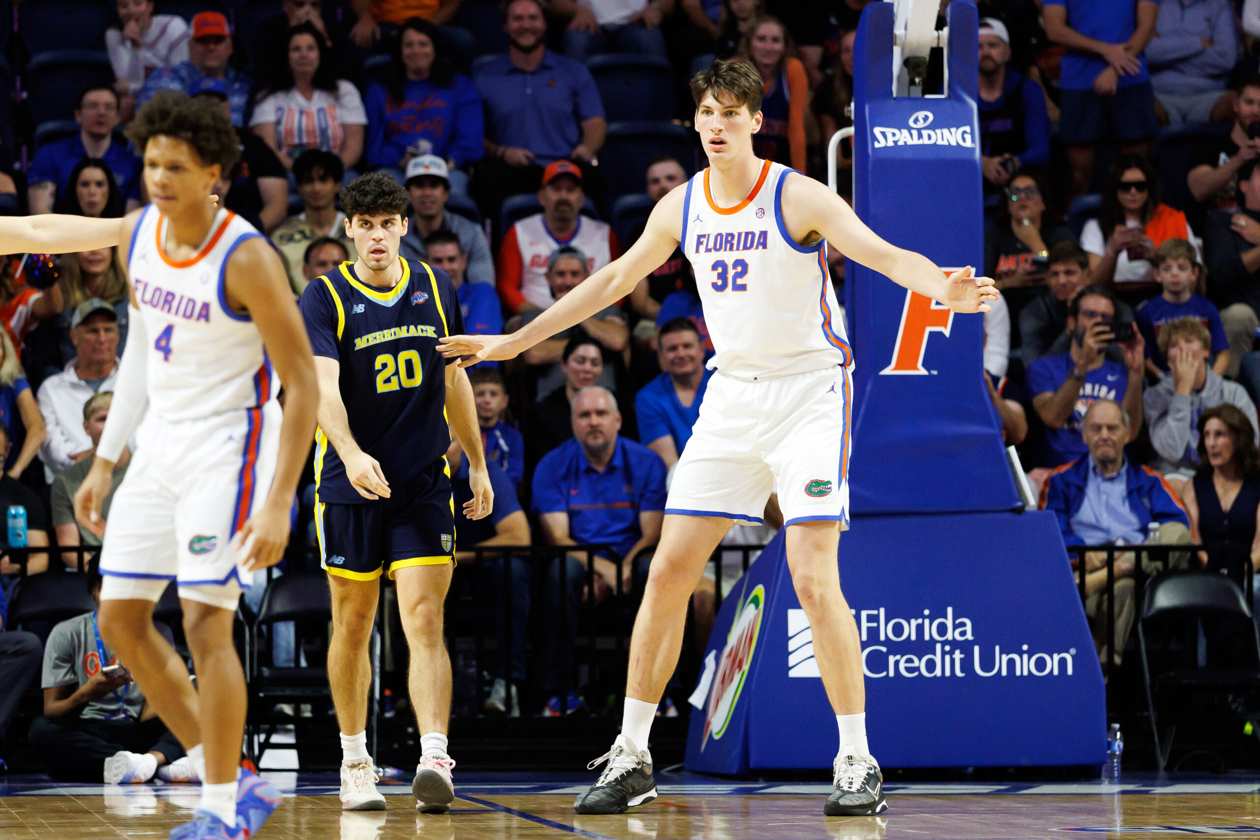 Nov 21, 2025; Gainesville, Florida, USA; Florida Gators center Olivier Rioux (32) defends Merrimack Warriors forward Todd Brogna (20) during the second half at Exactech Arena at the Stephen C. O'Connell Center. Mandatory Credit: Matt Pendleton-Imagn Images