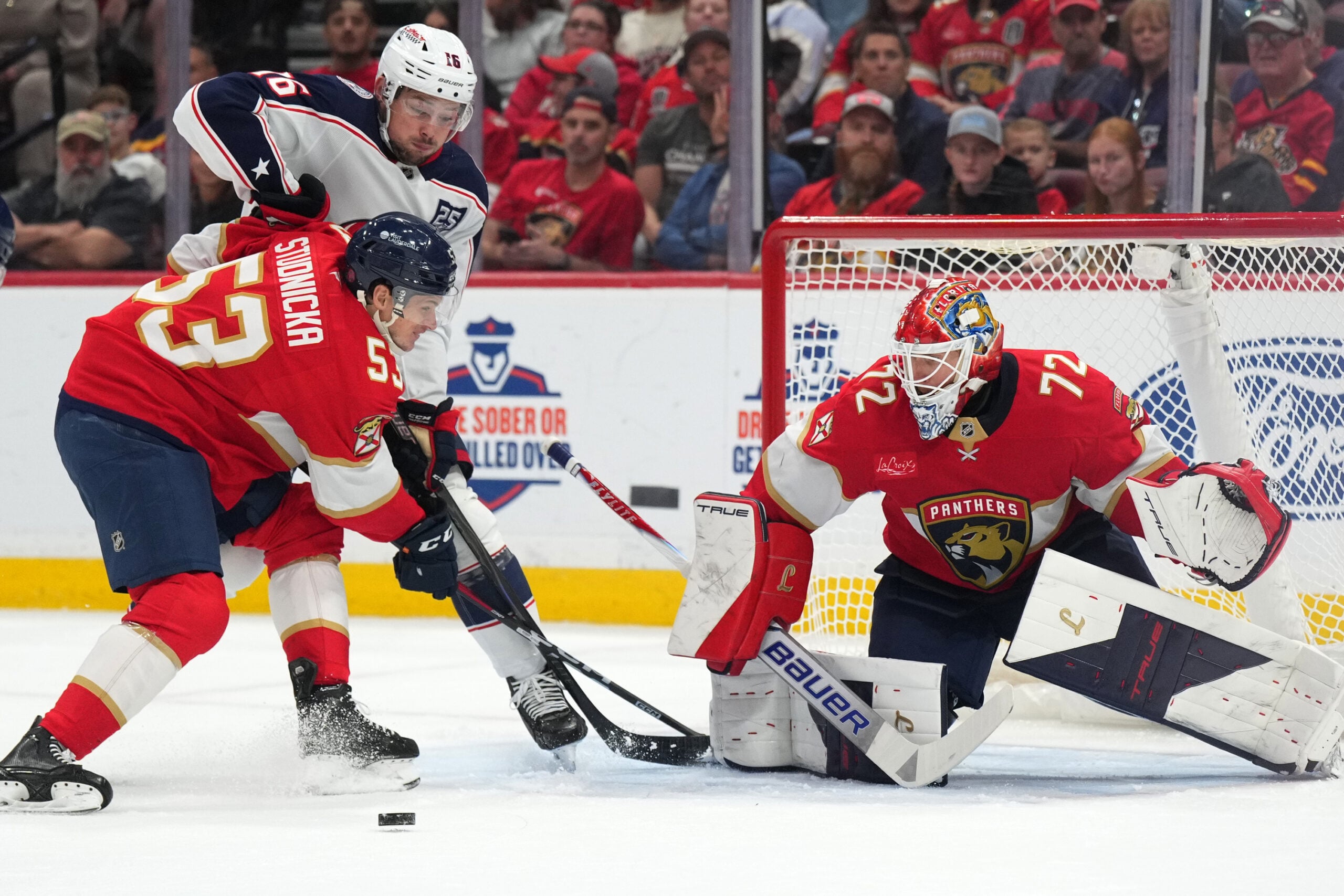 Dec 6, 2025; Sunrise, Florida, USA;  Florida Panthers center Jack Studnicka (53) defends Columbus Blue Jackets center Brendan Gaunce (16) as the puck goes toward the net during the first period at Amerant Bank Arena. Mandatory Credit: Jim Rassol-Imagn Images