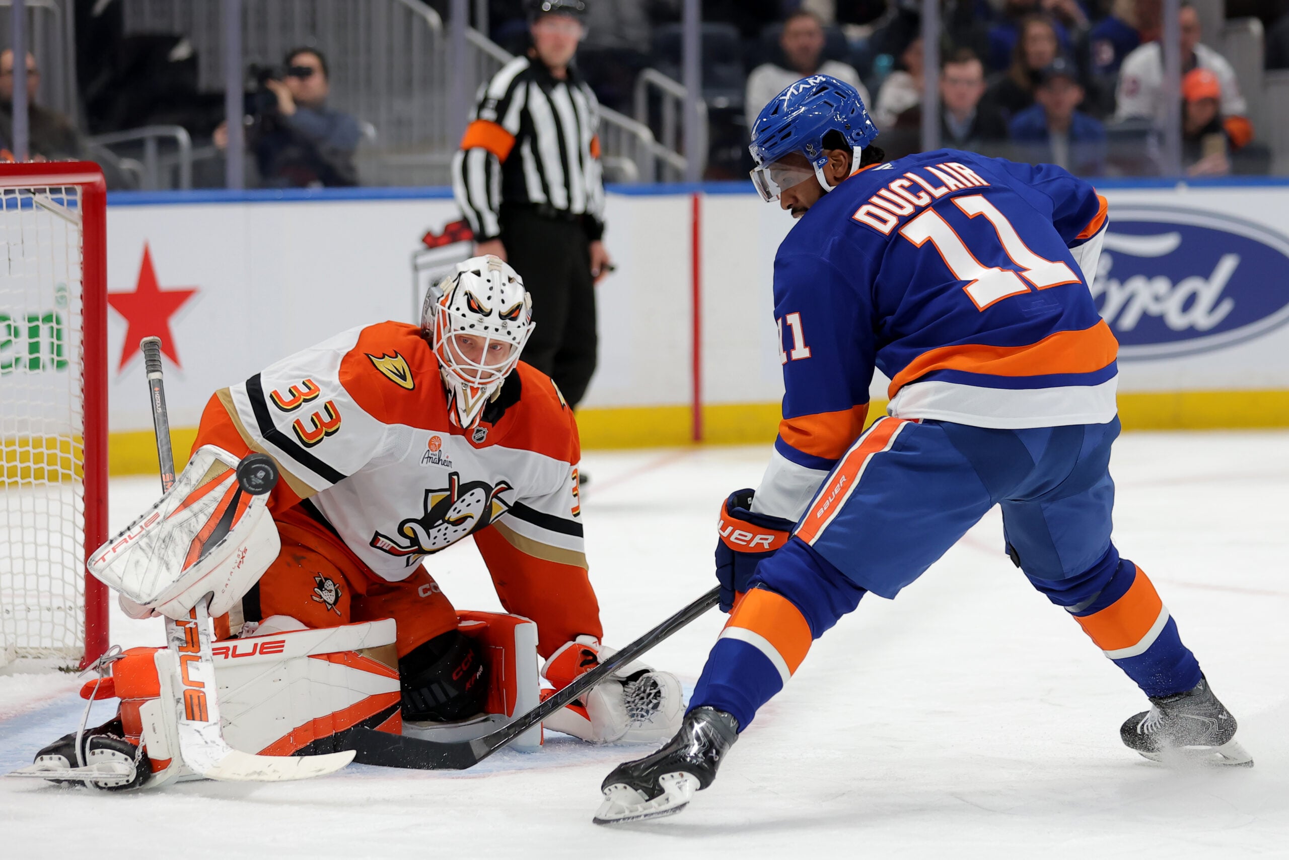 Dec 11, 2025; Elmont, New York, USA; Anaheim Ducks goaltender Ville Husso (33) makes a save against New York Islanders left wing Anthony Duclair (11) during the second period at UBS Arena. Mandatory Credit: Brad Penner-Imagn Images