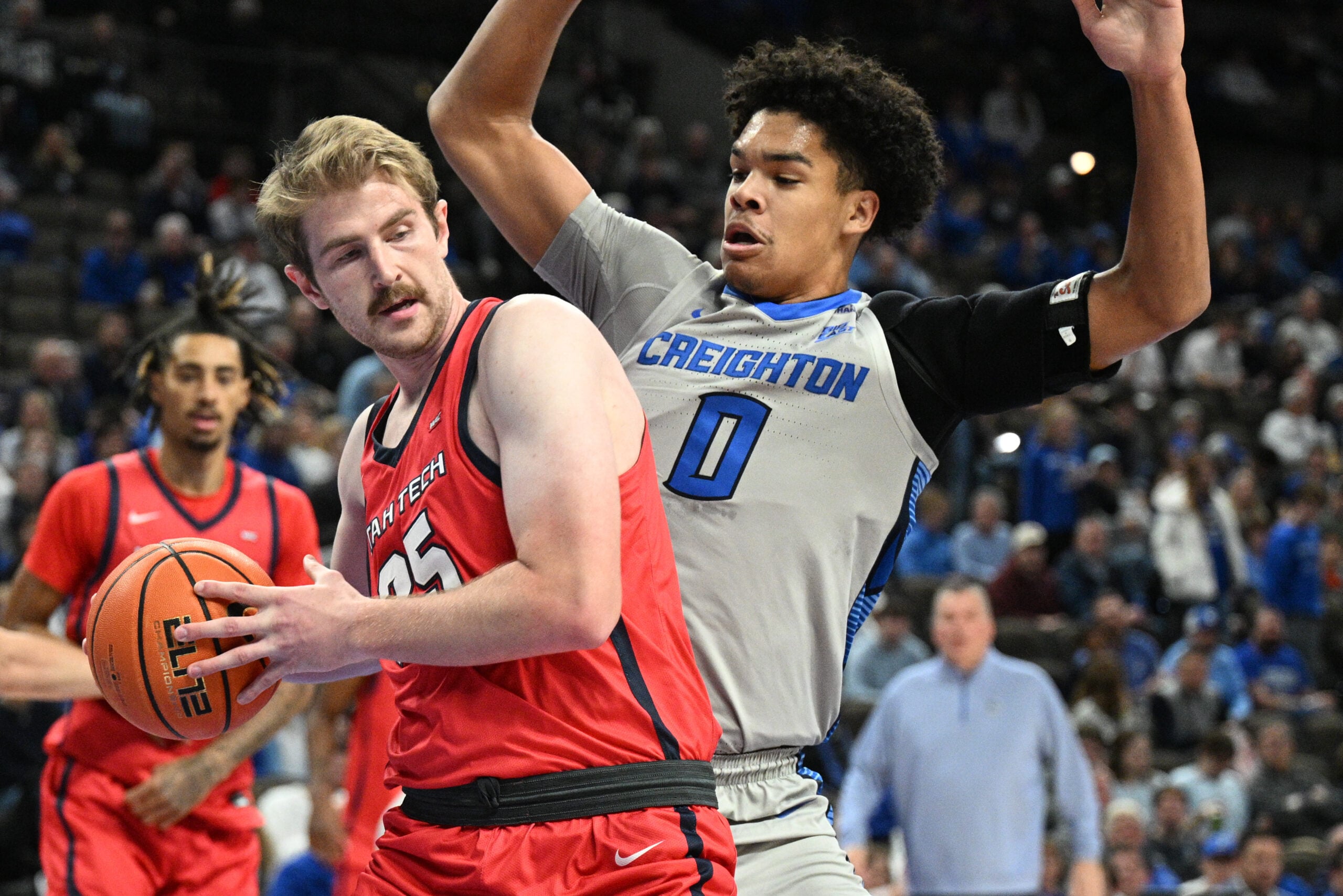 Dec 22, 2025; Omaha, Nebraska, USA;  Utah Tech Trailblazers forward Ethan Potter (35) drives against Creighton Bluejays forward Jasen Green (0) during the first half at CHI Health Center Omaha. Mandatory Credit: Steven Branscombe-Imagn Images