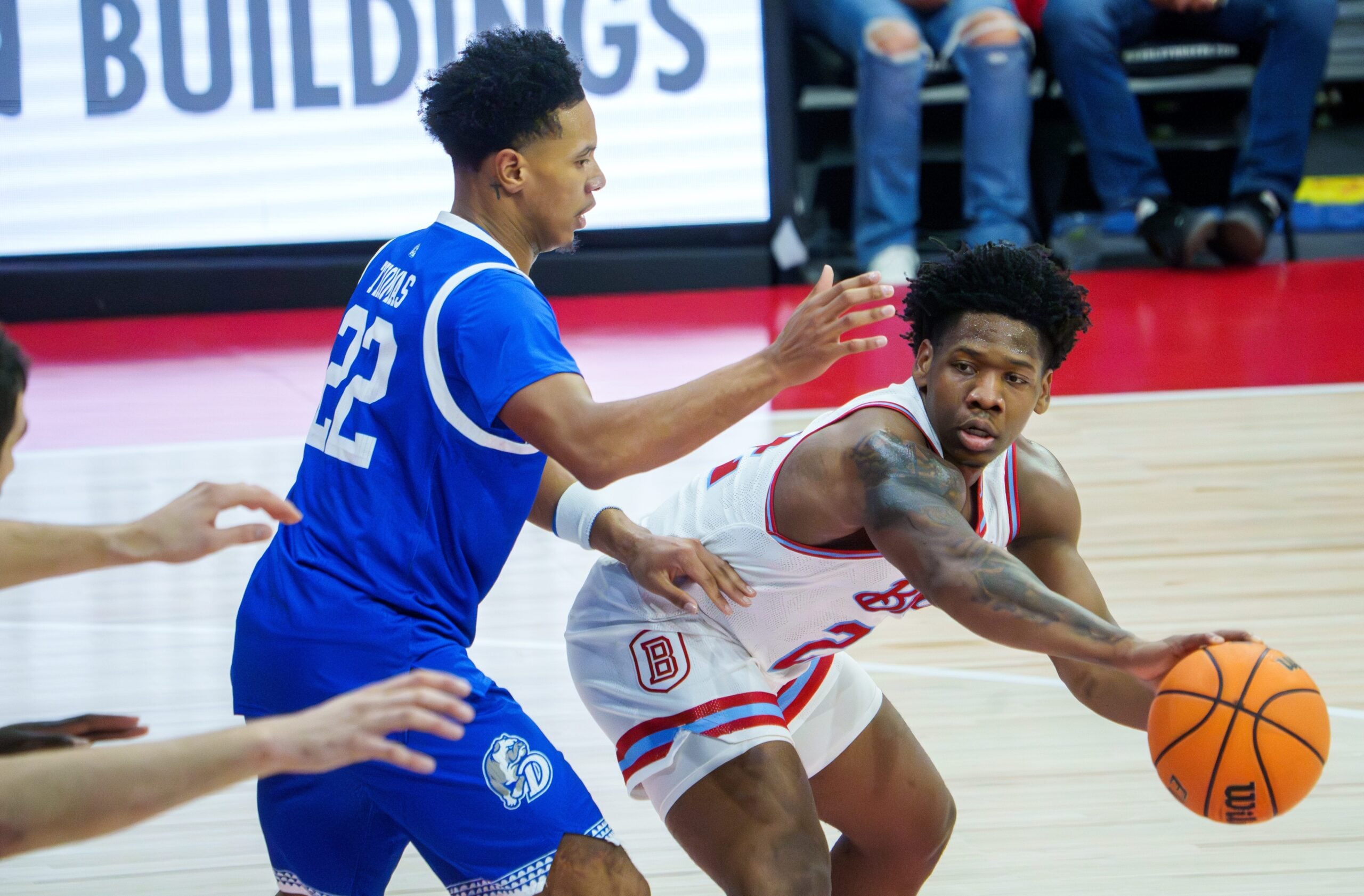 Bradley’s Jaquan Johnson, far right, passes the ball around Drake’s Jaehshon in the first half of their college basketball game Wednesday, Jan. 7, 2026 at Carver Arena in Peoria. The Braves defeated the Bulldogs 93-66.