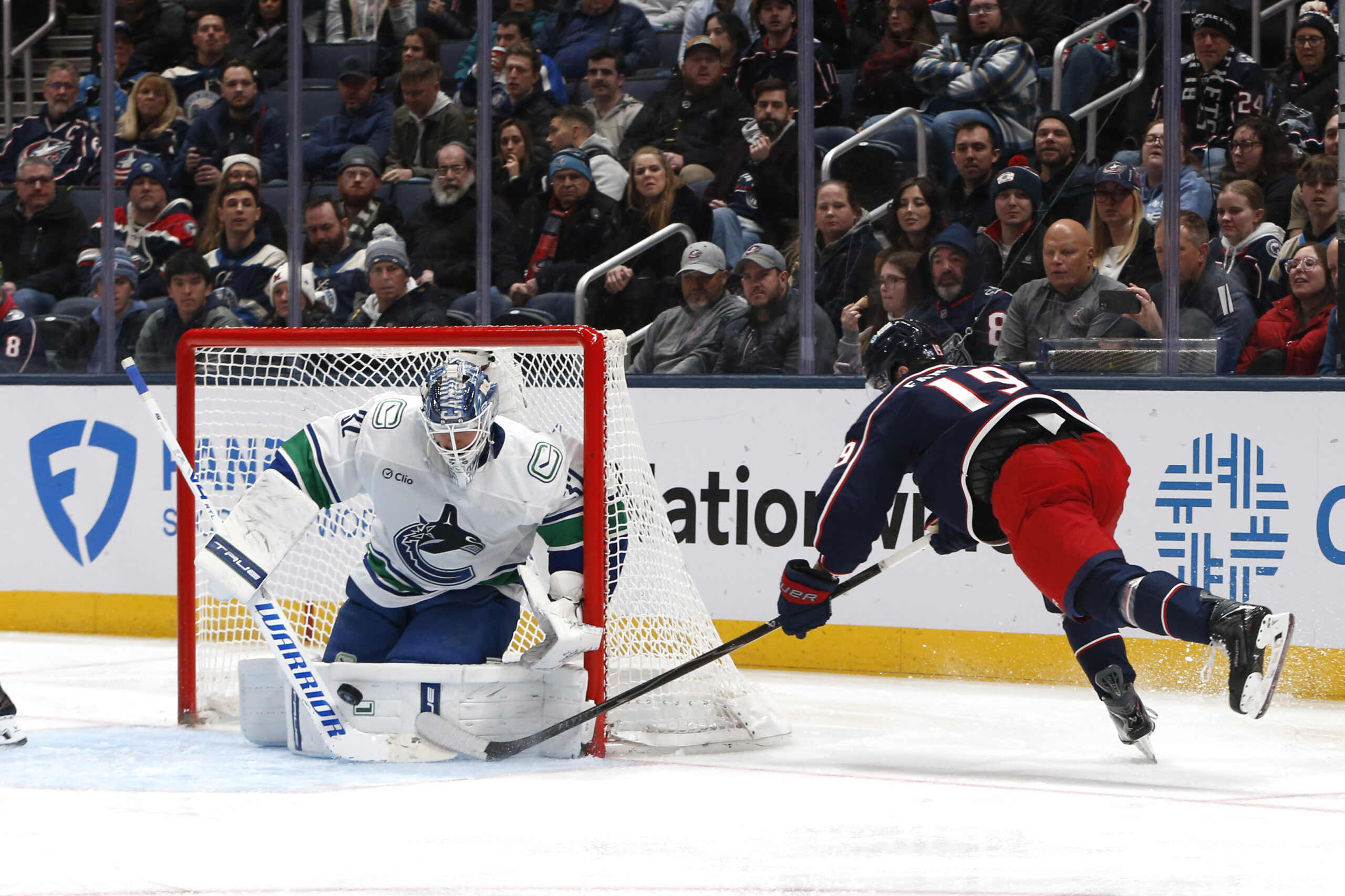 Jan 15, 2026; Columbus, Ohio, USA; Vancouver Canucks goalie Kevin Lankinen (32) makes a save on the shot attempt of Columbus Blue Jackets center Adam Fantilli (19) during the third period at Nationwide Arena. Mandatory Credit: Russell LaBounty-Imagn Images