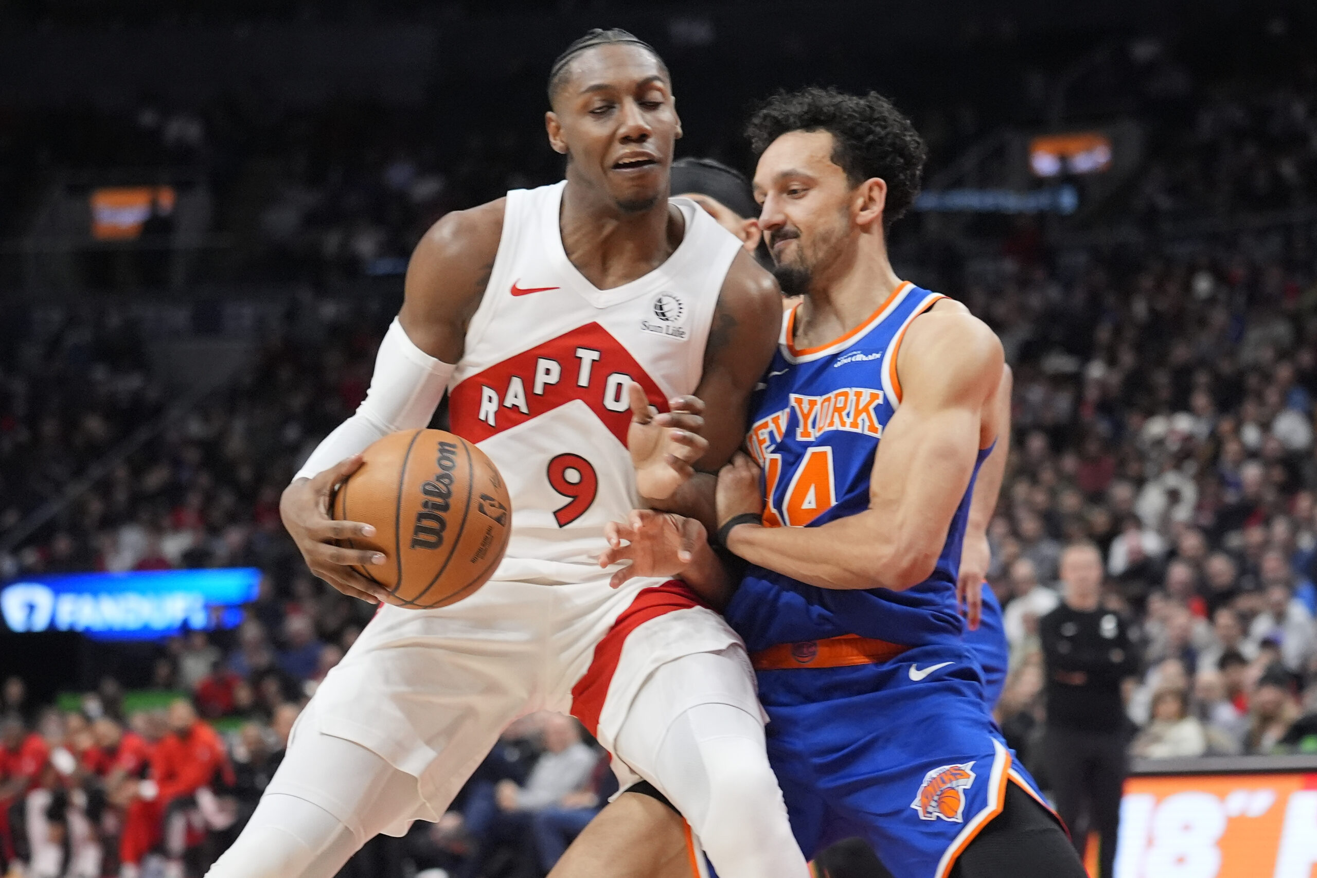 Jan 28, 2026; Toronto, Ontario, CAN; Toronto Raptors forward RJ Barrett (9) and New York Knicks guard Landry Shamet (44) battle for position during the second half at Scotiabank Arena. Mandatory Credit: John E. Sokolowski-Imagn Images
