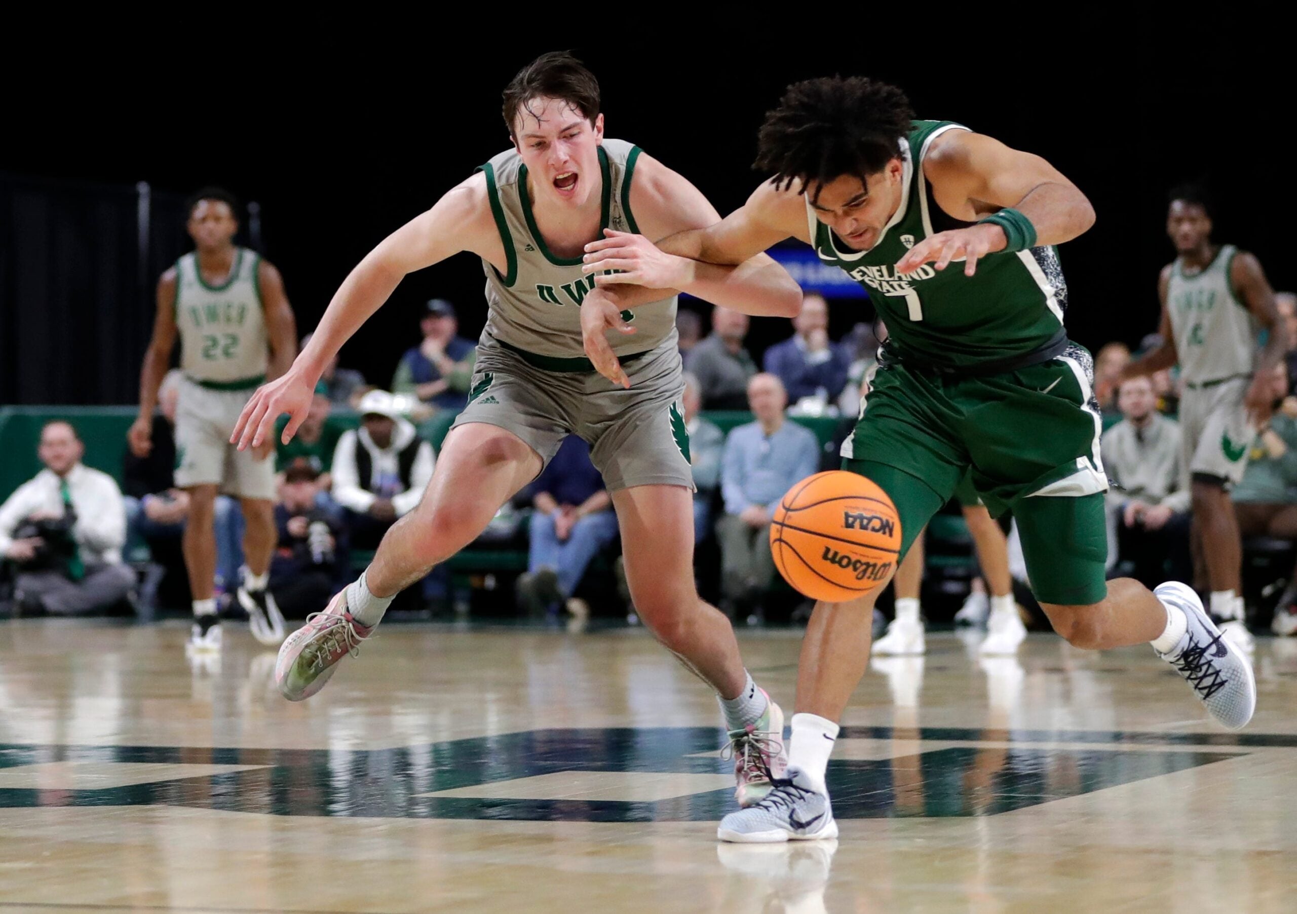University of Wisconsin-Green Bay's Marcus Hall (13) and Cleveland State's Dayan Nessah (7) fight for the ball during a basketball game on Jan. 30, 2026, at the Resch Center in Ashwaubenon, Wis. Cleveland State defeated UW-Green Bay 89-82.
