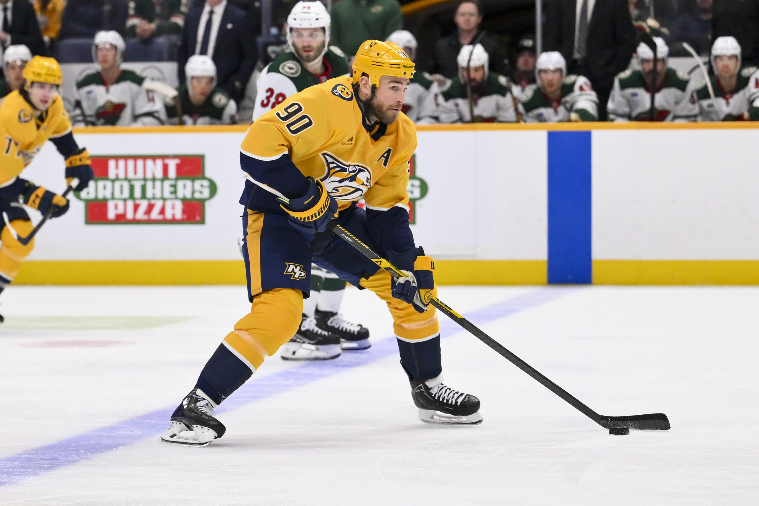 Feb 4, 2026; Nashville, Tennessee, USA; Nashville Predators center Ryan O'Reilly (90) skates with the puck against the Minnesota Wild during the third period at Bridgestone Arena. Mandatory Credit: Steve Roberts-Imagn Images
