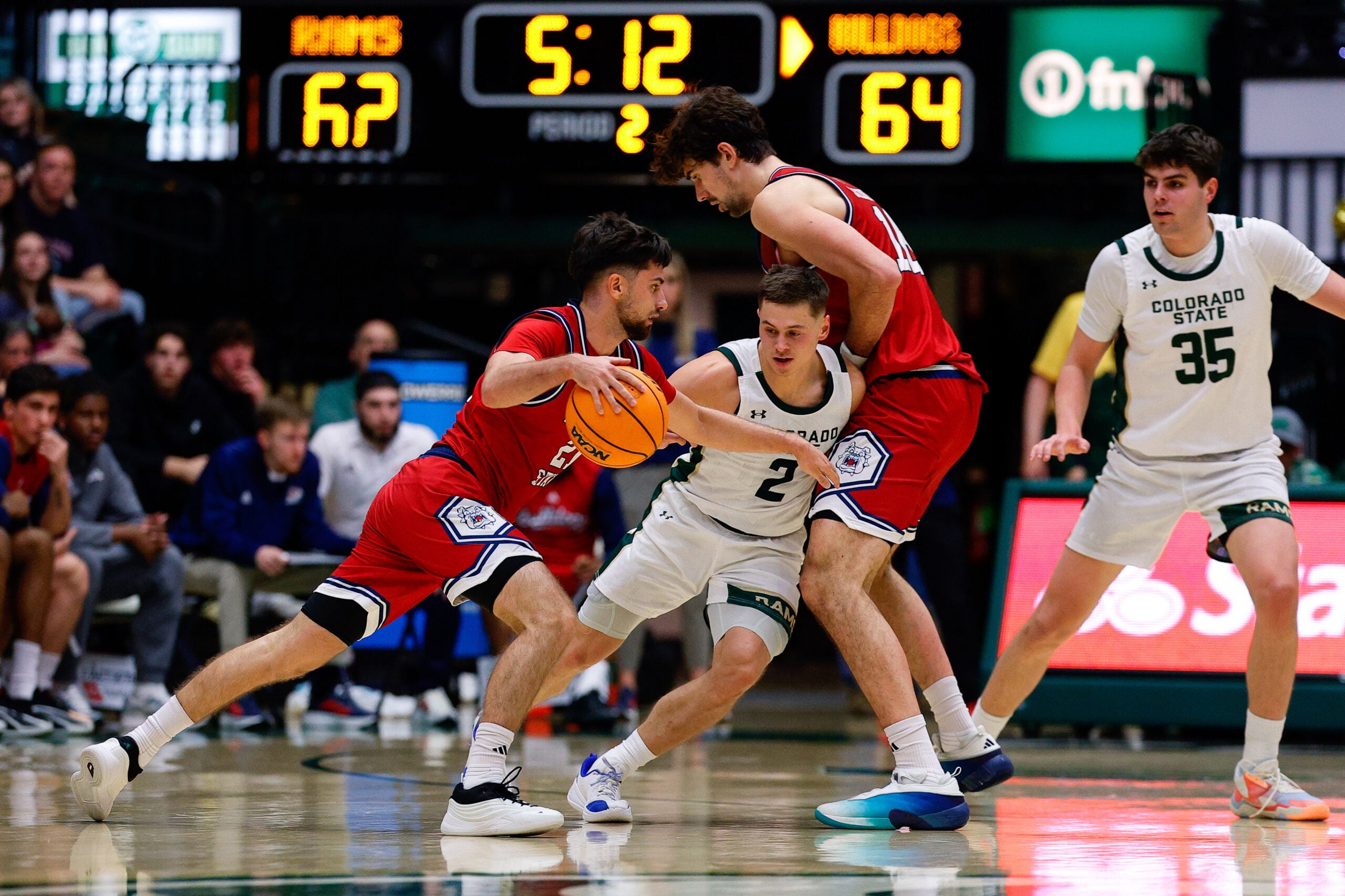 Feb 24, 2026; Fort Collins, Colorado, USA; Fresno State Bulldogs guard Bastien Rieber (21) controls the ball as center Wilson Jacques (16) screens against Colorado State Rams guard Brandon Rechsteiner (2) as forward Kyle Jorgensen (35) defends in the second half at Moby Arena. Mandatory Credit: Isaiah J. Downing-Imagn Images