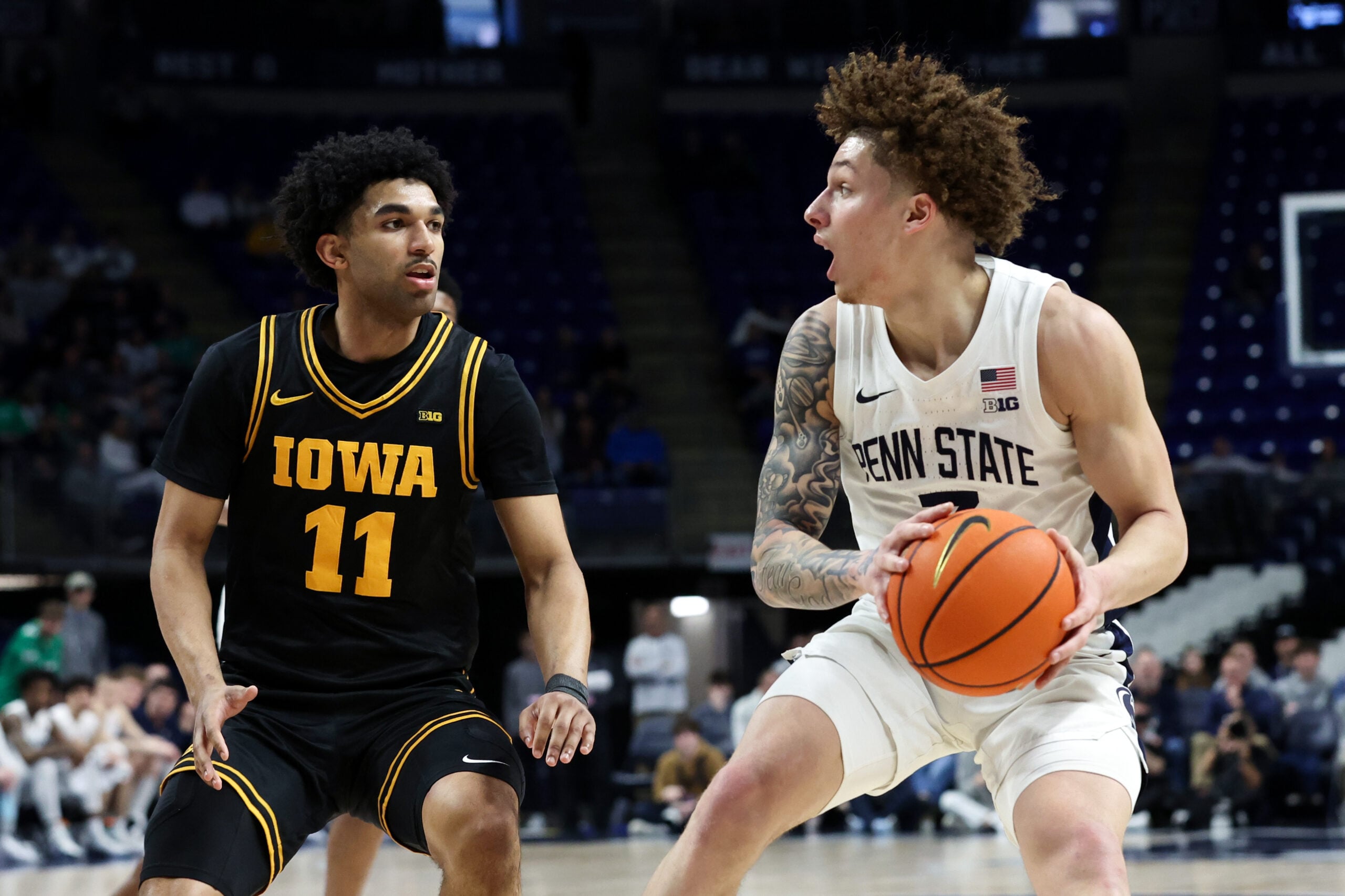 Feb 28, 2026; University Park, Pennsylvania, USA; Penn State Nittany Lions guard Dominick Stewart (7) looks to pass the ball as Iowa Hawkeyes guard Kael Combs (11) defends during the first half at Bryce Jordan Center. Mandatory Credit: Matthew O'Haren-Imagn Images