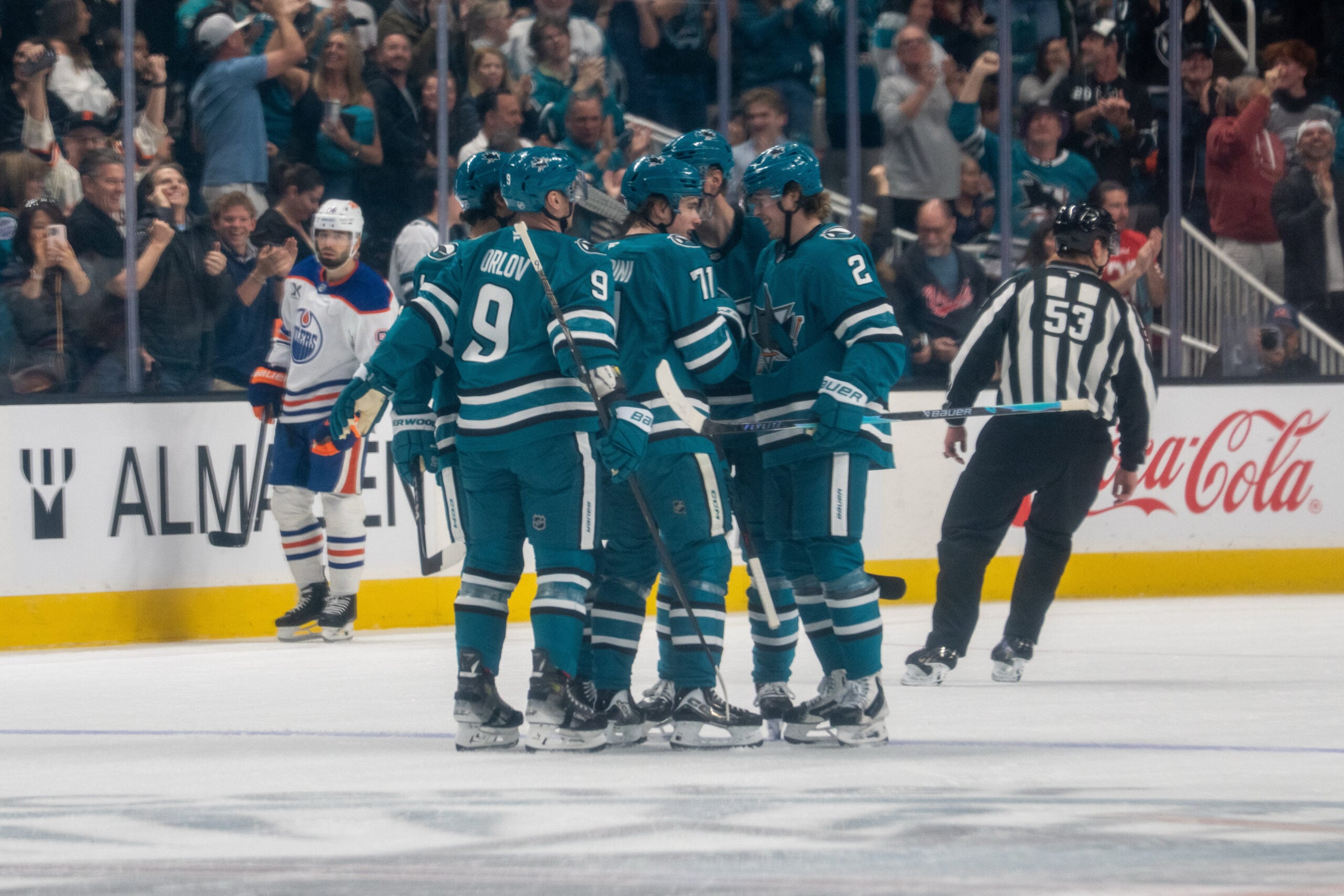 Feb 28, 2026; San Jose, California, USA; San Jose Sharks center Macklin Celebrini (71) celebrates with San Jose Sharks defenseman Dmitry Orlov (9) and teammates after scoring a goal against the Edmonton Oilers during the first period at SAP Center at San Jose. Mandatory Credit: Neville E. Guard-Imagn Images