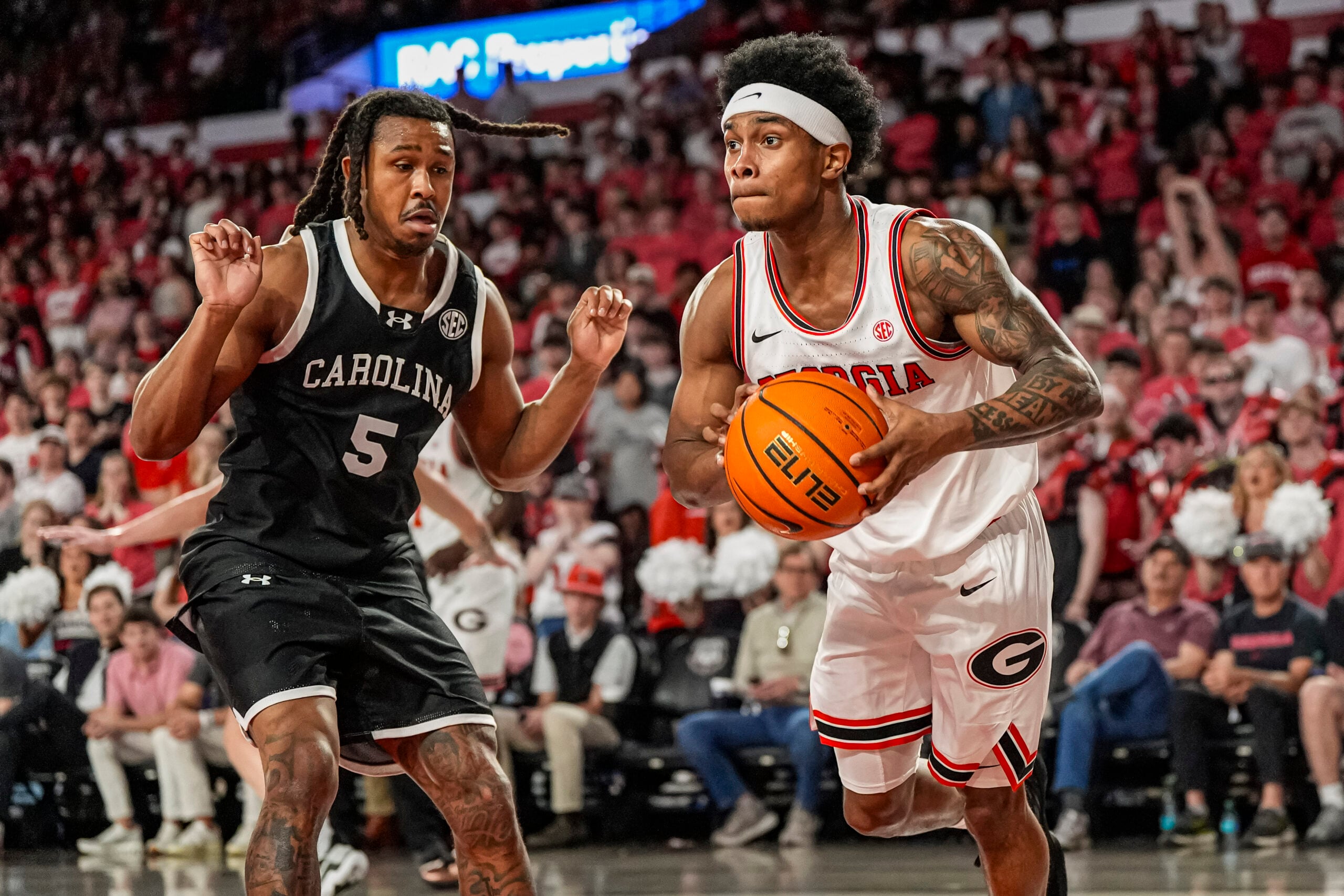 Feb 28, 2026; Athens, Georgia, USA; Georgia Bulldogs guard Marcus Millender (4) passes the ball in front of South Carolina Gamecocks guard Meechie Johnson (5) during the first half at Stegeman Coliseum. Mandatory Credit: Dale Zanine-Imagn Images