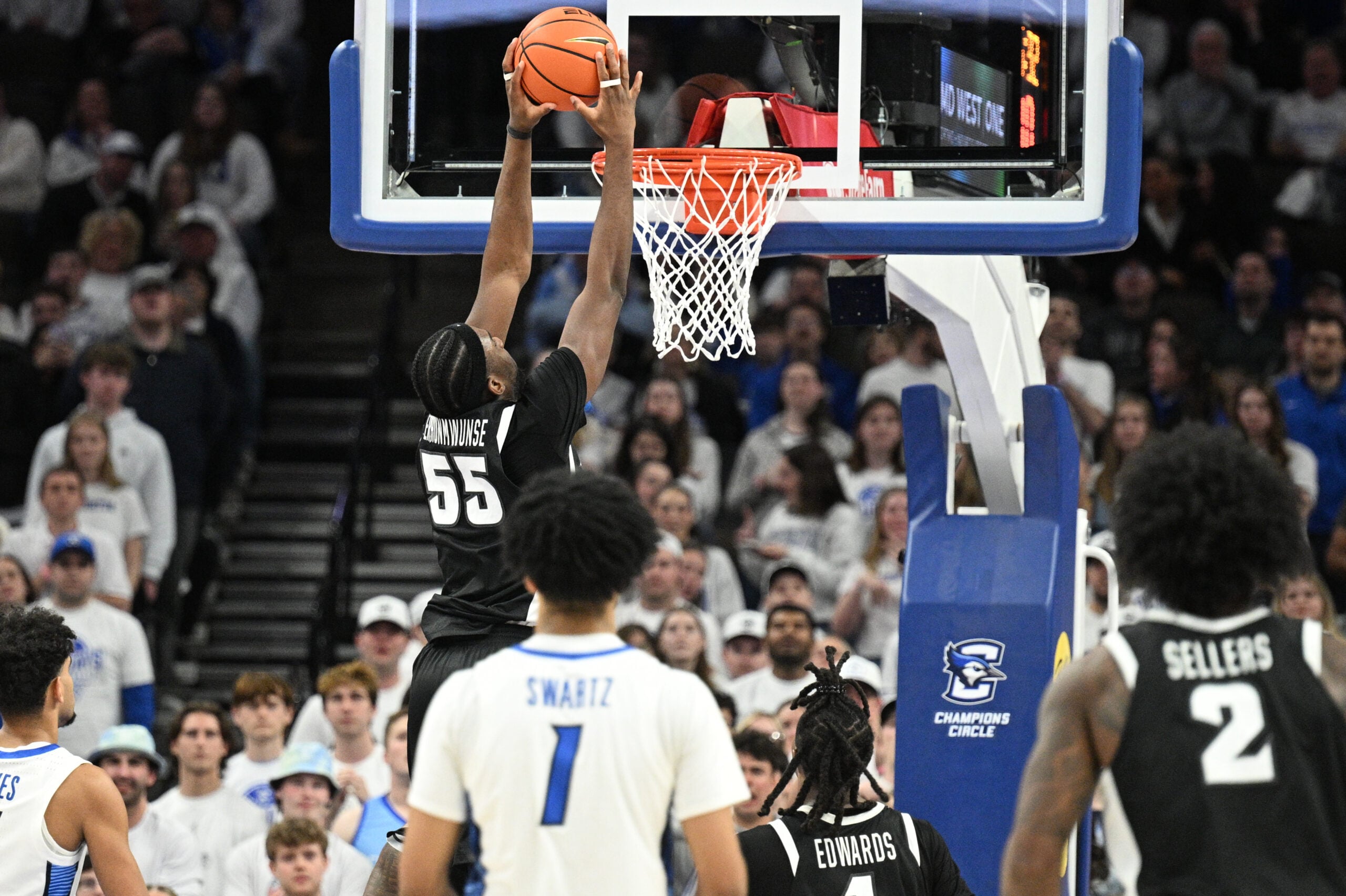 Feb 28, 2026; Omaha, Nebraska, USA;  Providence Friars forward Oswin Erhunmwunse (55) dunks against the Creighton Bluejays during the second half at CHI Health Center Omaha. Mandatory Credit: Steven Branscombe-Imagn Images