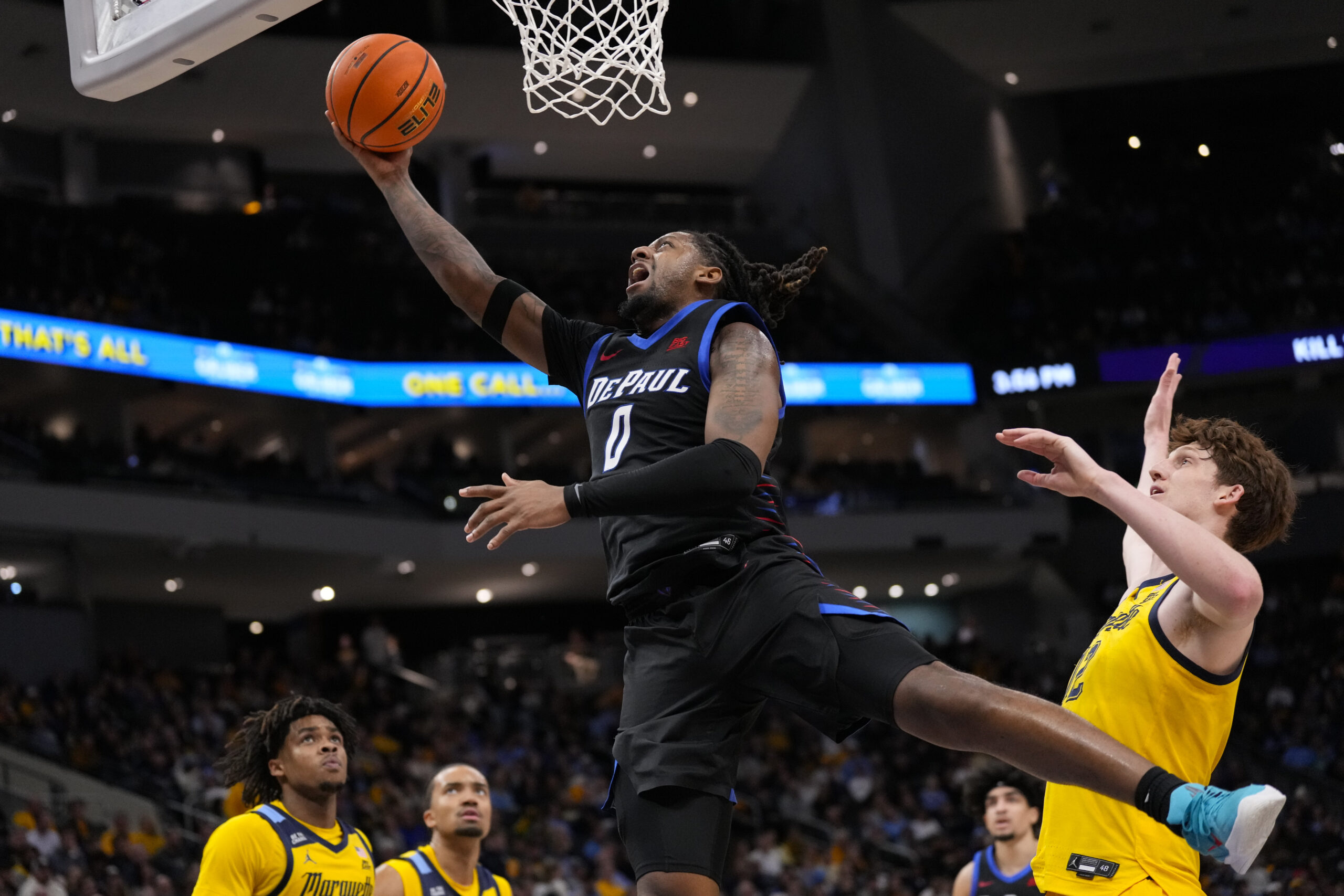 Mar 1, 2026; Milwaukee, Wisconsin, USA;  DePaul Blue Demons guard Brandon Maclin (0) shoots in front of jMarquette Golden Eagles forward Ben Gold (12) during the first half at Fiserv Forum. Mandatory Credit: Jeff Hanisch-Imagn Images