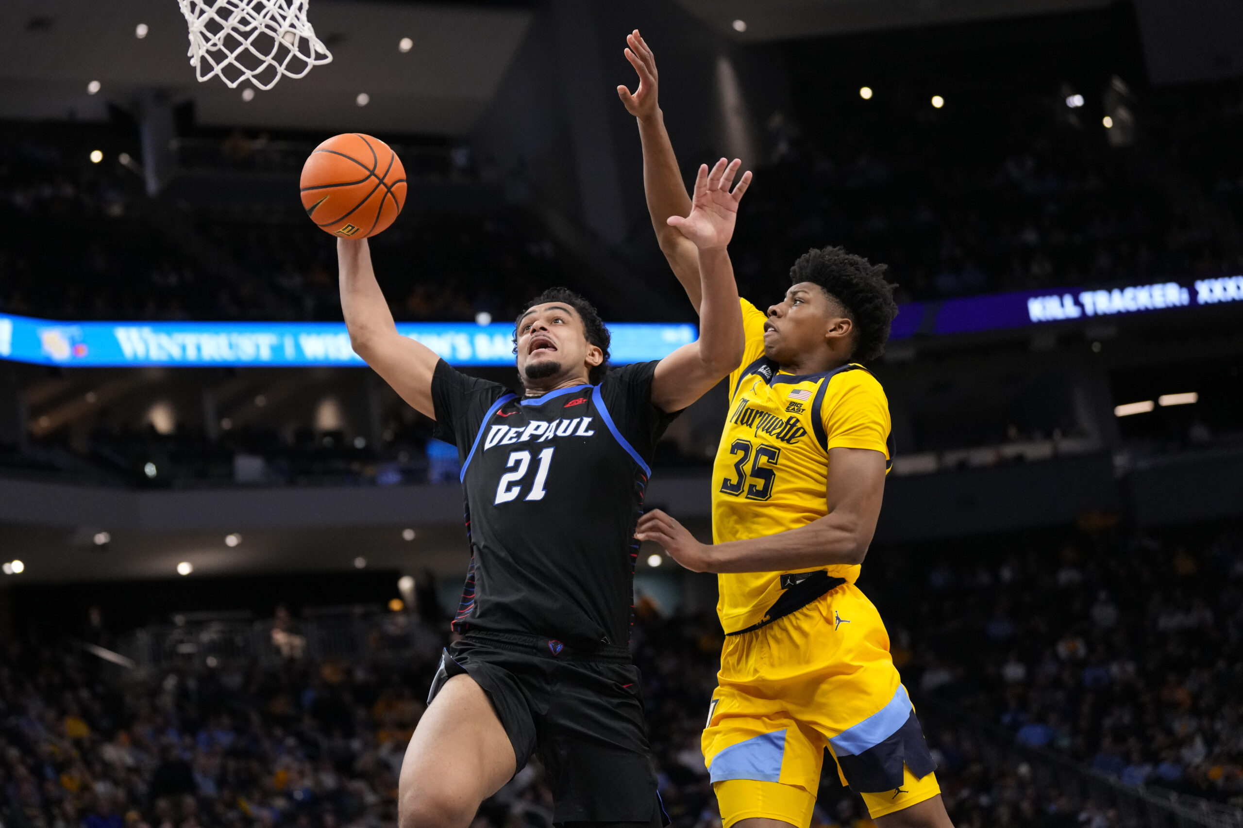 Mar 1, 2026; Milwaukee, Wisconsin, USA;  DePaul Blue Demons forward Theo Pierre-Justin (21) drives for a slam dunk against Marquette Golden Eagles forward Michael Phillips II (35) during the first half at Fiserv Forum. Mandatory Credit: Jeff Hanisch-Imagn Images