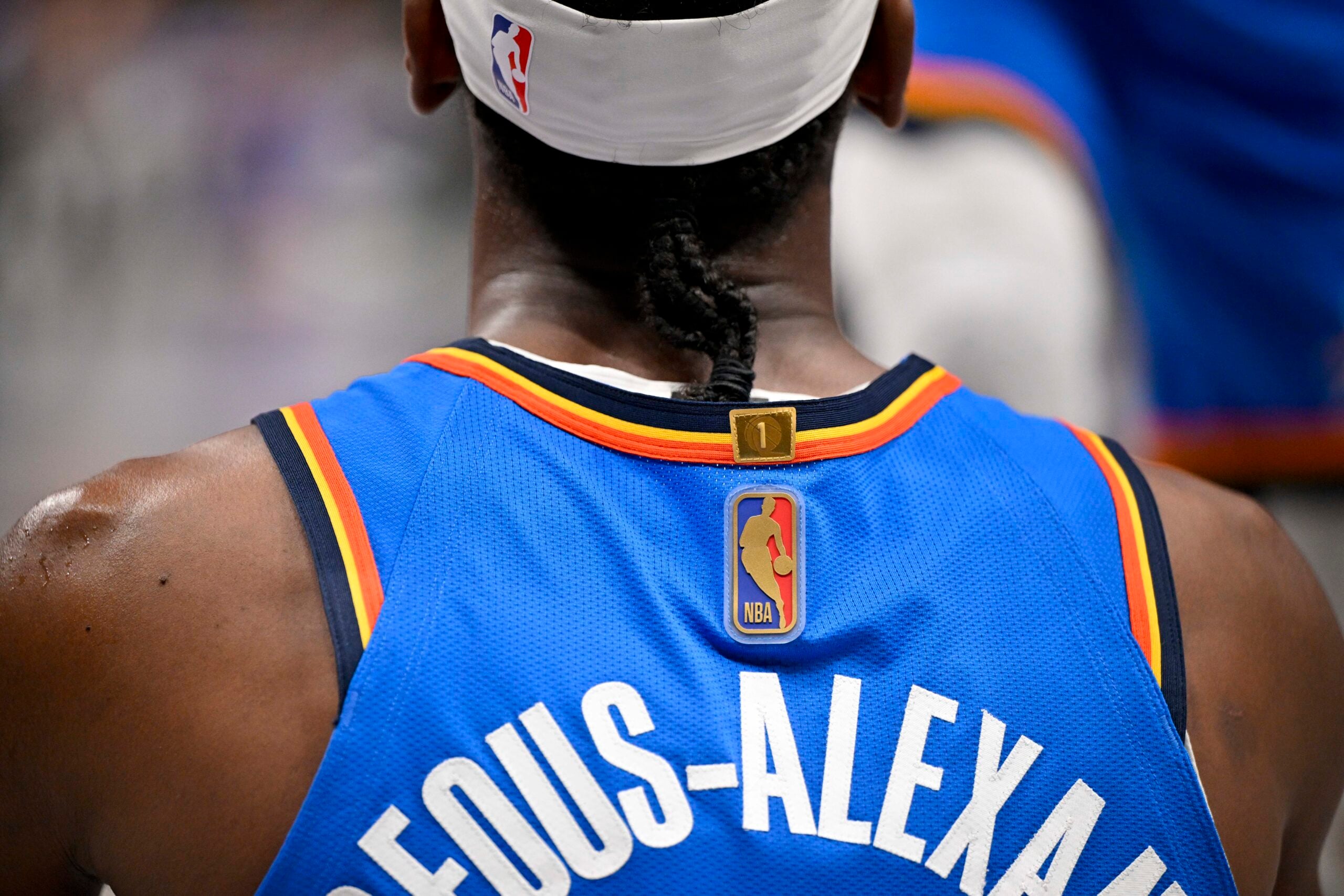 Mar 1, 2026; Dallas, Texas, USA; A view of the gold NBA logo on the jersey of Oklahoma City Thunder guard Shai Gilgeous-Alexander (2) during the second half against the Dallas Mavericks at the American Airlines Center. Mandatory Credit: Jerome Miron-Imagn Images