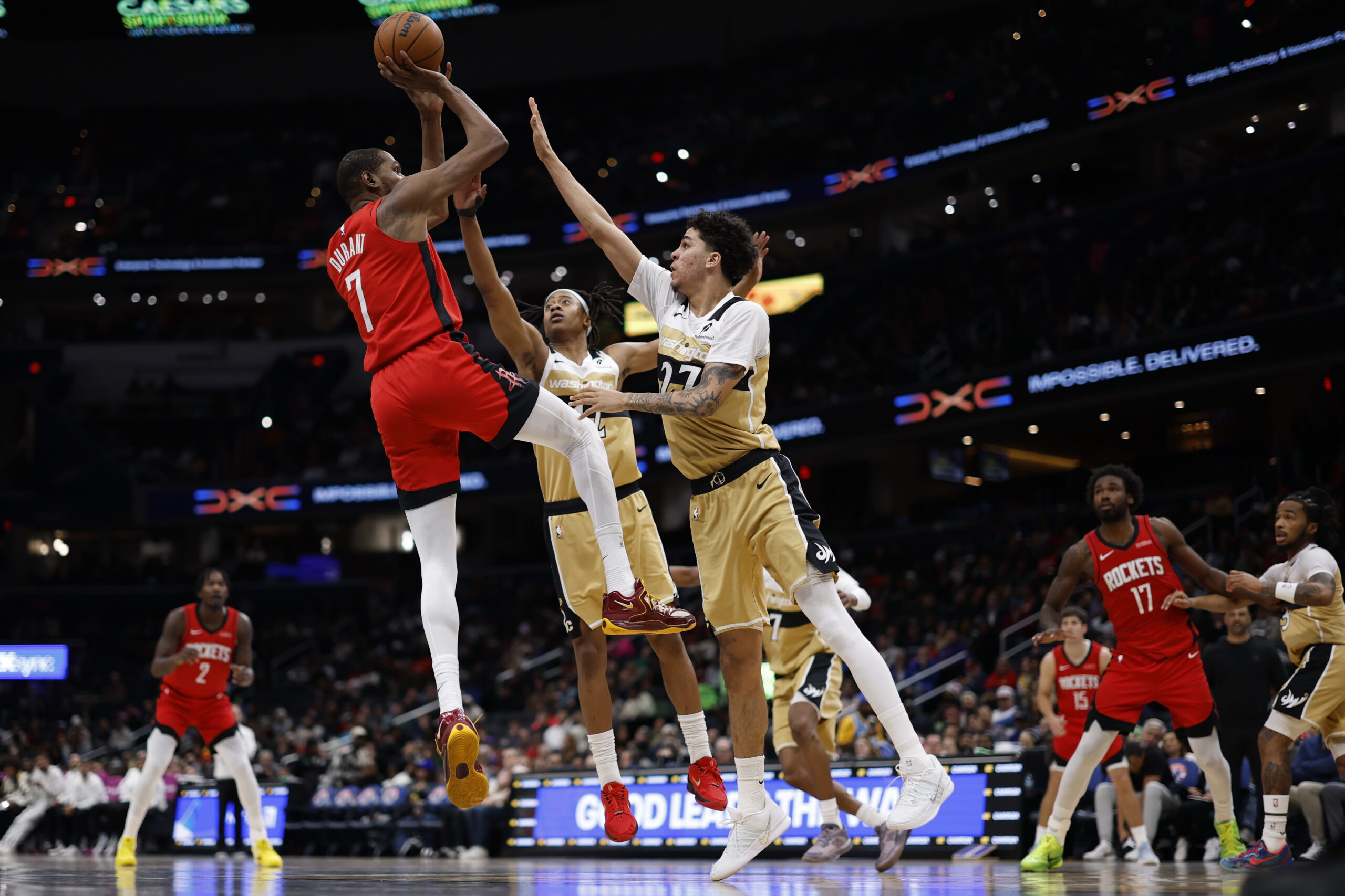 Mar 2, 2026; Washington, District of Columbia, USA; Houston Rockets forward Kevin Durant (7) shoots the ball over Washington Wizards guard Tre Johnson (12) and Wizards guard Will Riley (27) in the second half at Capital One Arena. Mandatory Credit: Geoff Burke-Imagn Images