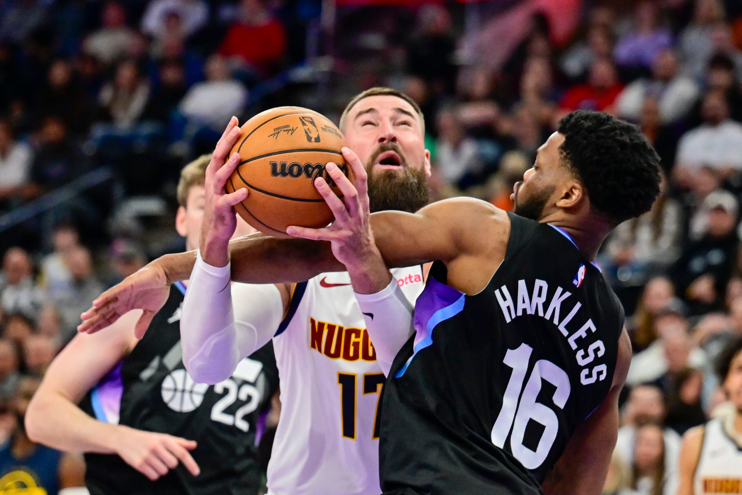 Mar 2, 2026; Salt Lake City, Utah, USA; Utah Jazz guard Elijah Harkless (16) fouls Denver Nuggets center Jonas Valančiūnas (17) during the second half at Delta Center. Mandatory Credit: Peter Creveling-Imagn Images