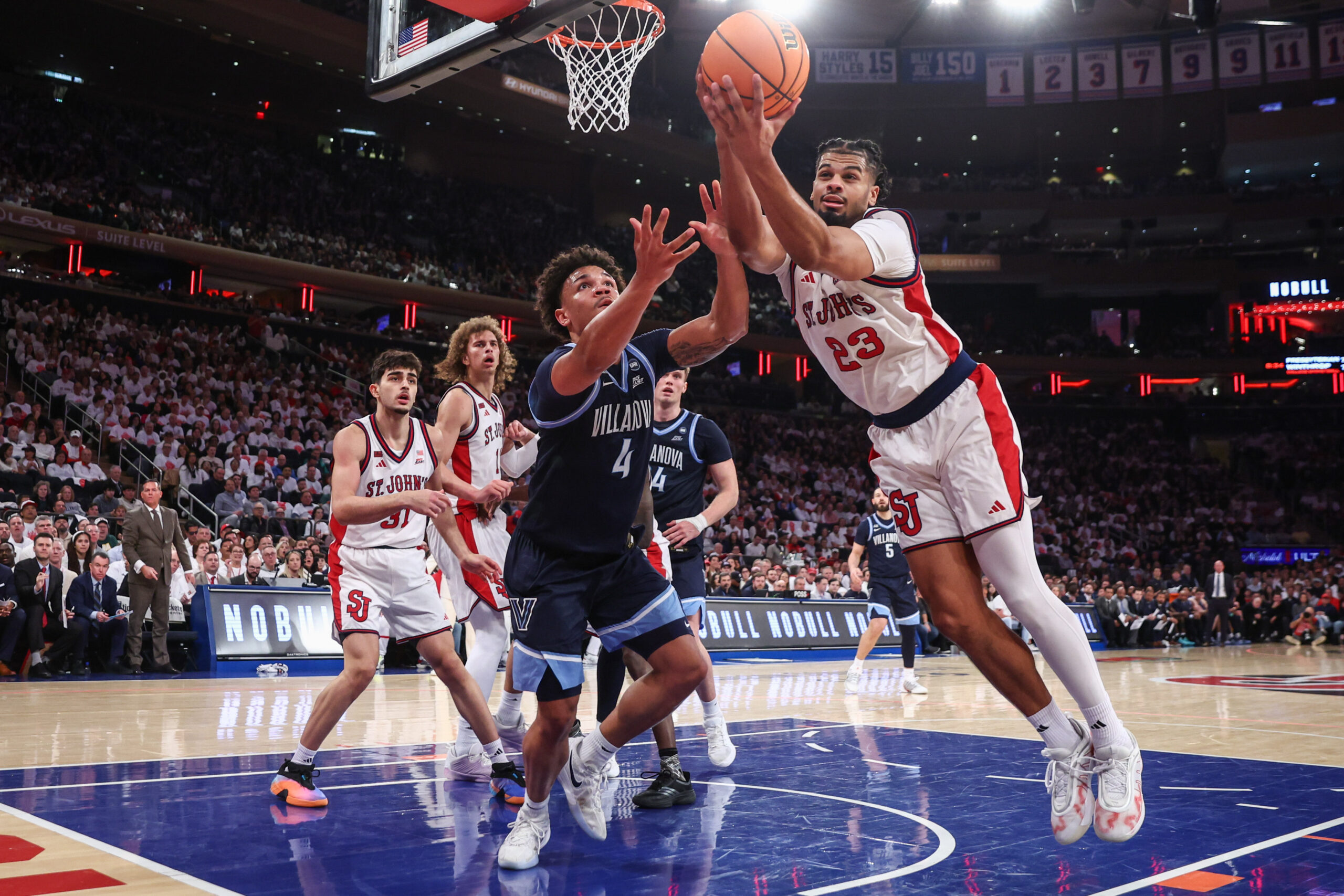 Feb 28, 2026; New York, New York, USA;  Villanova Wildcats guard Tyler Perkins (4) and St. John's Red Storm forward Bryce Hopkins (23) at Madison Square Garden. Mandatory Credit: Wendell Cruz-Imagn Images