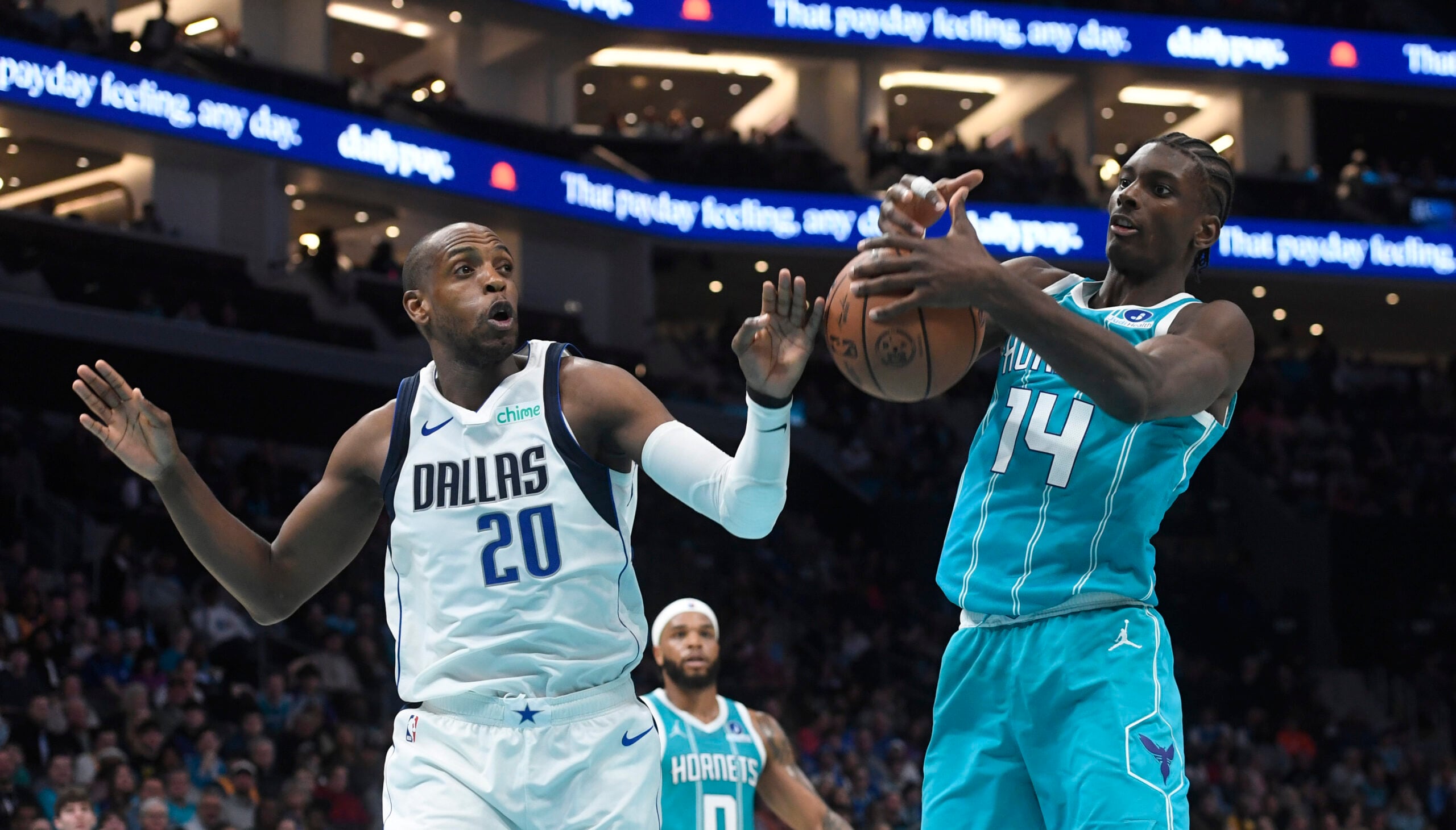 Mar 3, 2026; Charlotte, North Carolina, USA;  Dallas Mavericks forward Khris Middleton (20) and Charlotte Hornets forward center Moussa Diabate (14) fight for a rebound during the first half at the Spectrum Center. Mandatory Credit: Sam Sharpe-Imagn Images