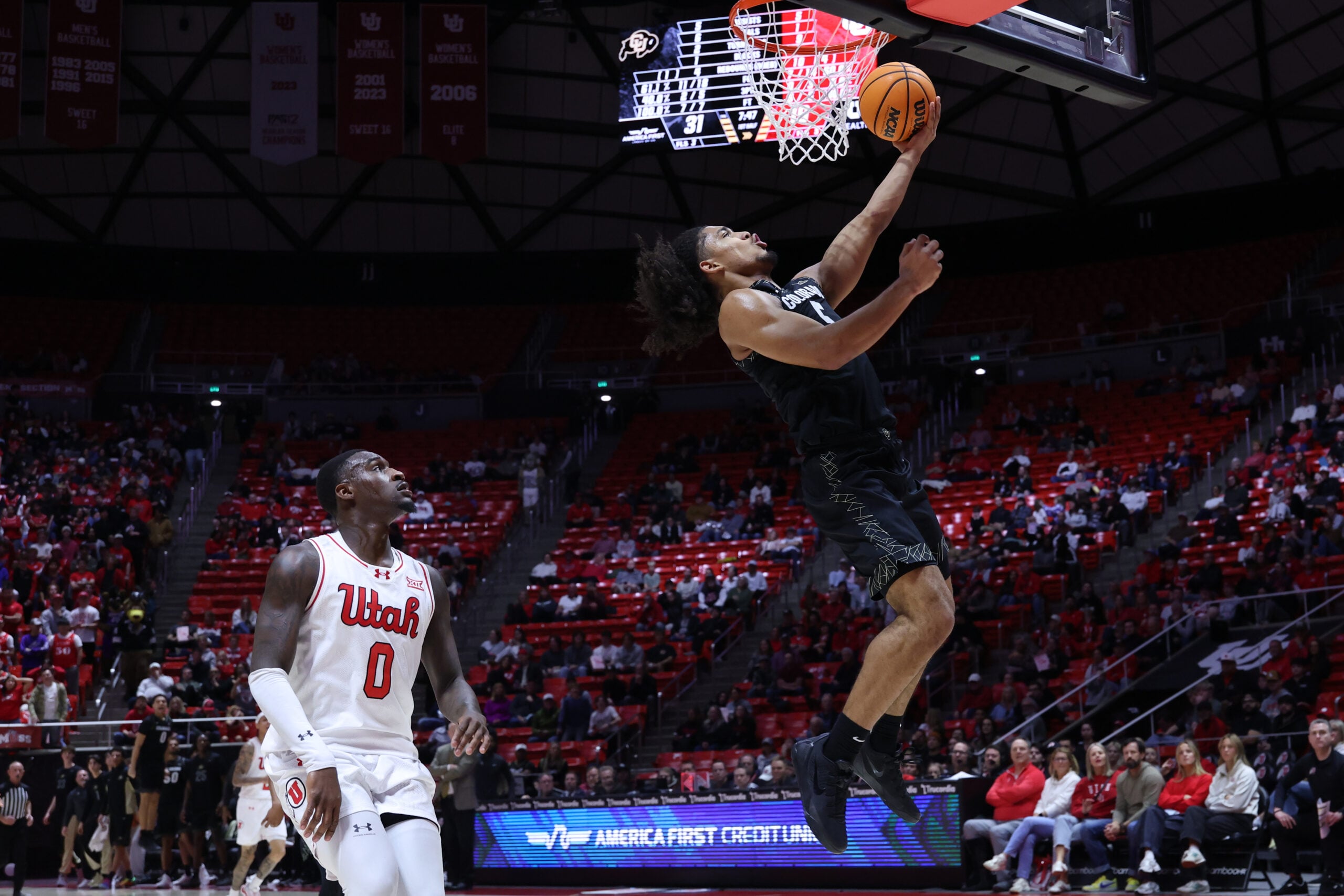 Mar 3, 2026; Salt Lake City, Utah, USA; Colorado Buffaloes guard Josiah Sanders (5) goes for a lay up against Utah Utes forward Seydou Traore (0) during the first half at Jon M. Huntsman Center. Mandatory Credit: Rob Gray-Imagn Images