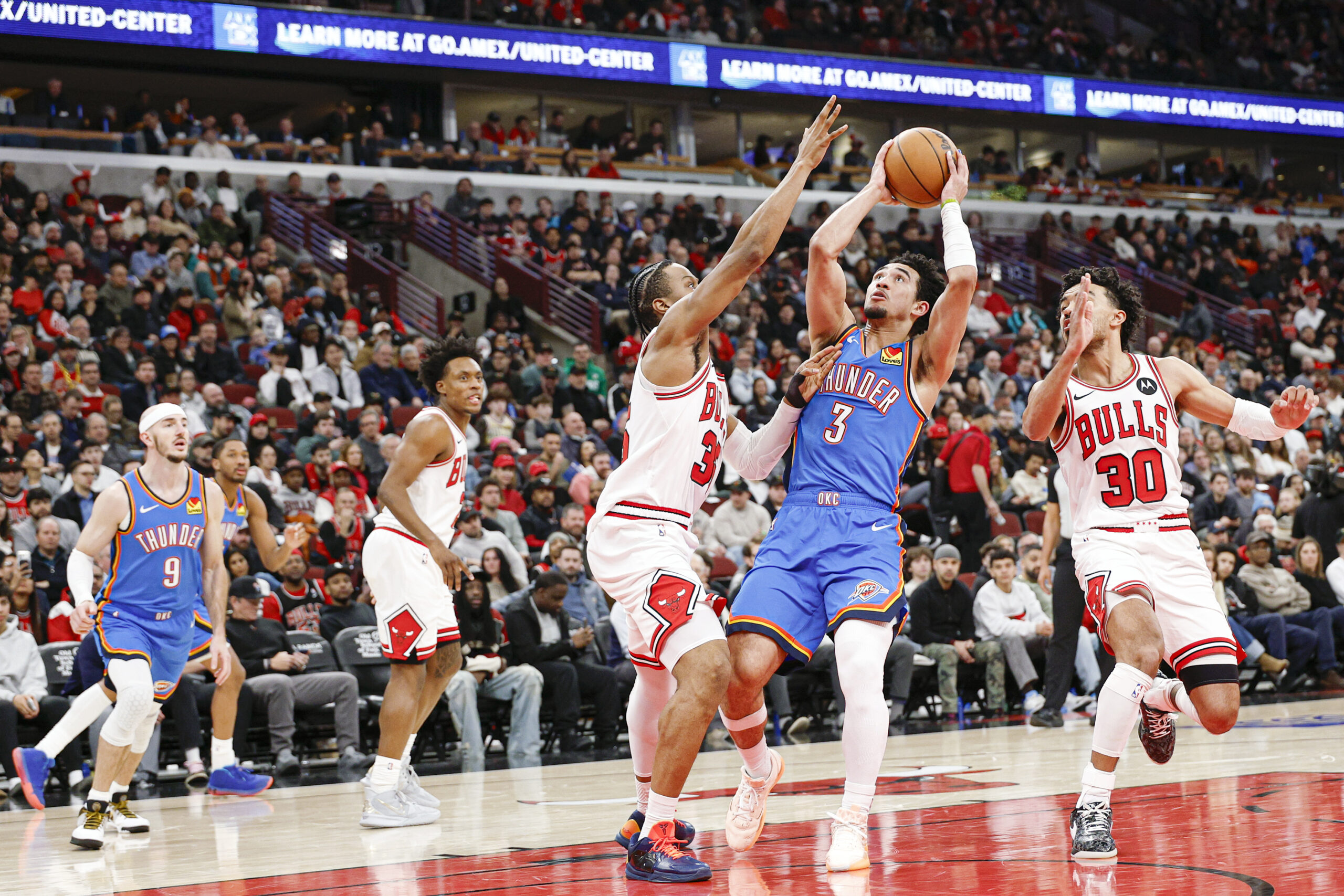 Mar 3, 2026; Chicago, Illinois, USA; Oklahoma City Thunder guard Jared McCain (3) shoots against Chicago Bulls forward Isaac Okoro (35) during the second half at United Center. Mandatory Credit: Kamil Krzaczynski-Imagn Images