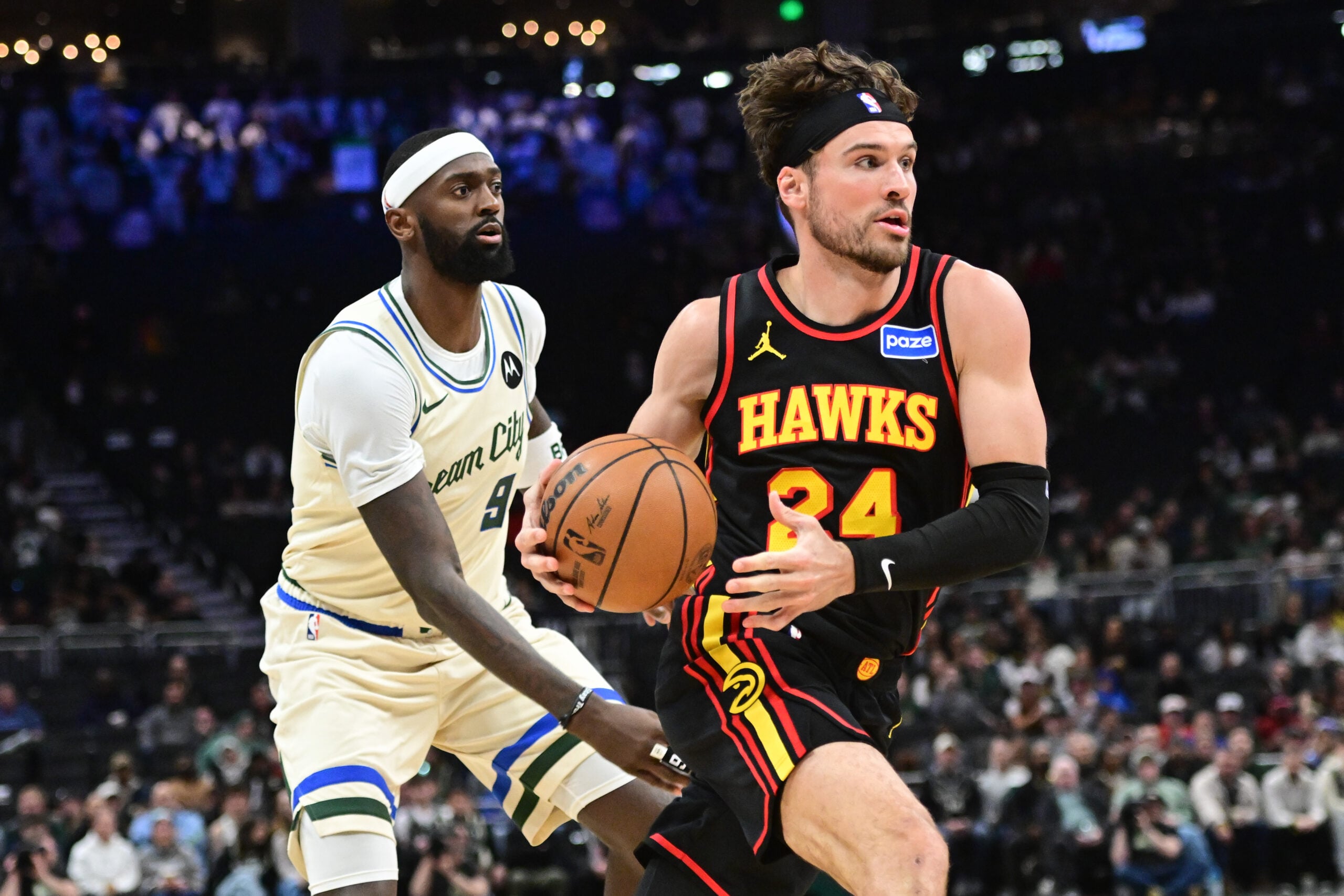Mar 4, 2026; Milwaukee, Wisconsin, USA; Atlanta Hawks guard Corey Kispert (24) drives for the basket against Milwaukee Bucks forward Bobby Portis (9) in the third quarter at Fiserv Forum. Mandatory Credit: Benny Sieu-Imagn Images