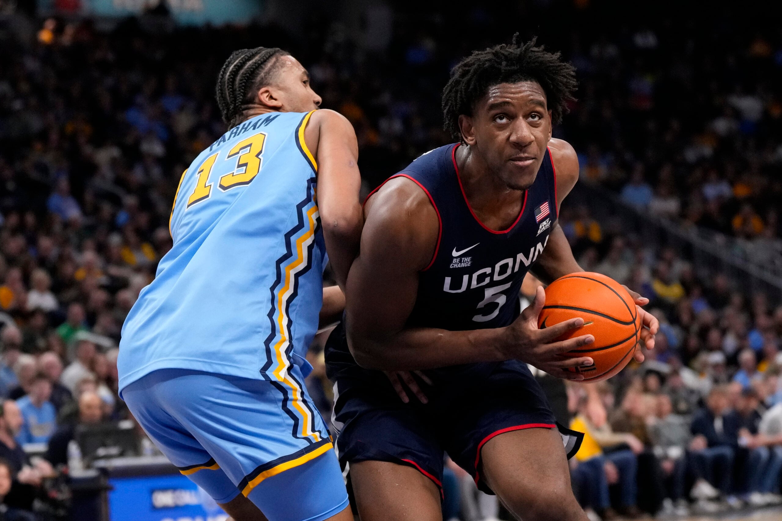 Mar 7, 2026; Milwaukee, Wisconsin, USA;  Connecticut Huskies center Tarris Reed Jr. (5) looks to shoot against Marquette Golden Eagles forward Royce Parham (13) during the first half at Fiserv Forum. Mandatory Credit: Jeff Hanisch-Imagn Images