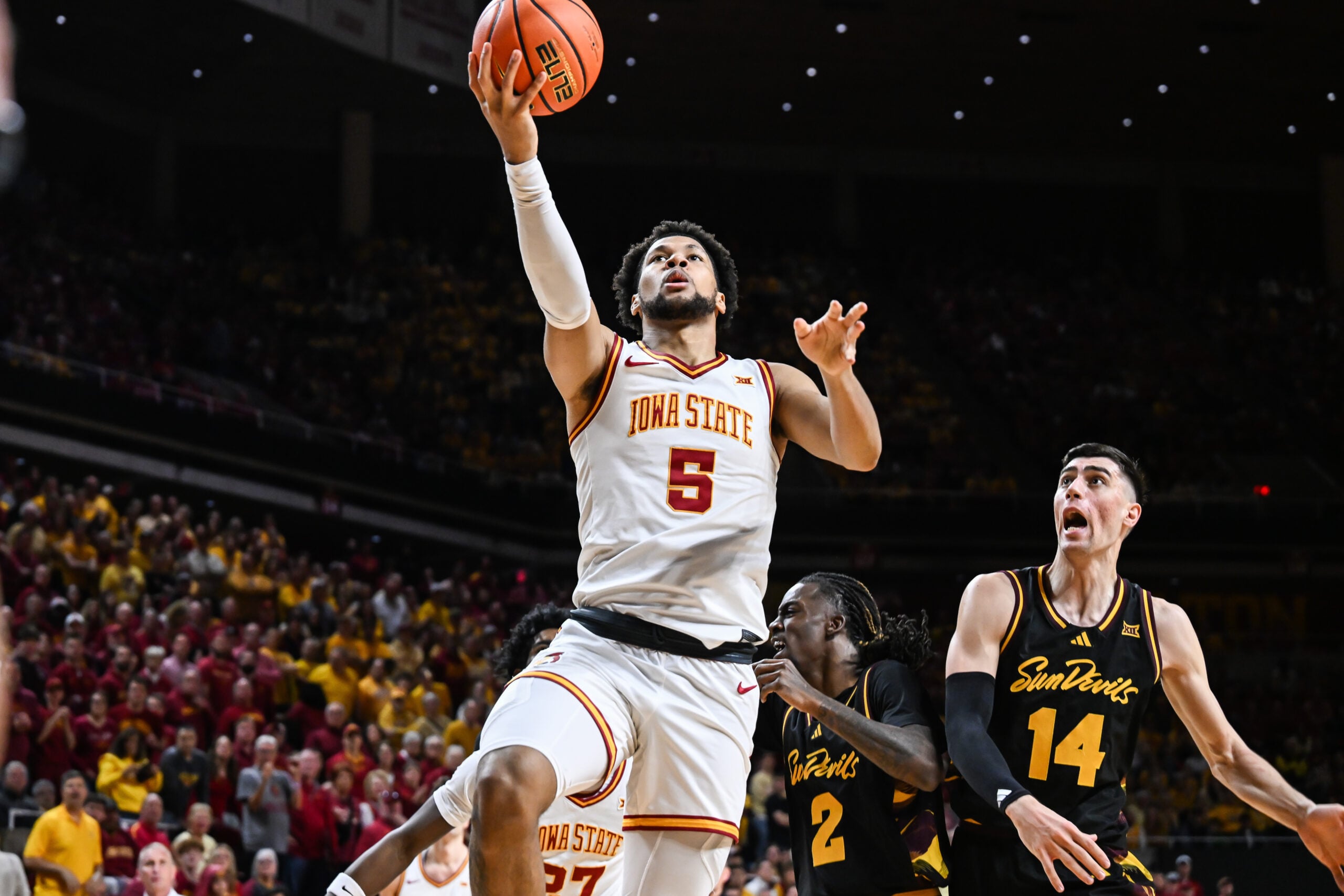 Mar 7, 2026; Ames, Iowa, USA; Iowa State Cyclones forward Joshua Jefferson (5) goes to the basket as Arizona State Sun Devils forward Andrija Grbovic (14) defends during the first half at James H. Hilton Coliseum. Mandatory Credit: Jeffrey Becker-Imagn Images