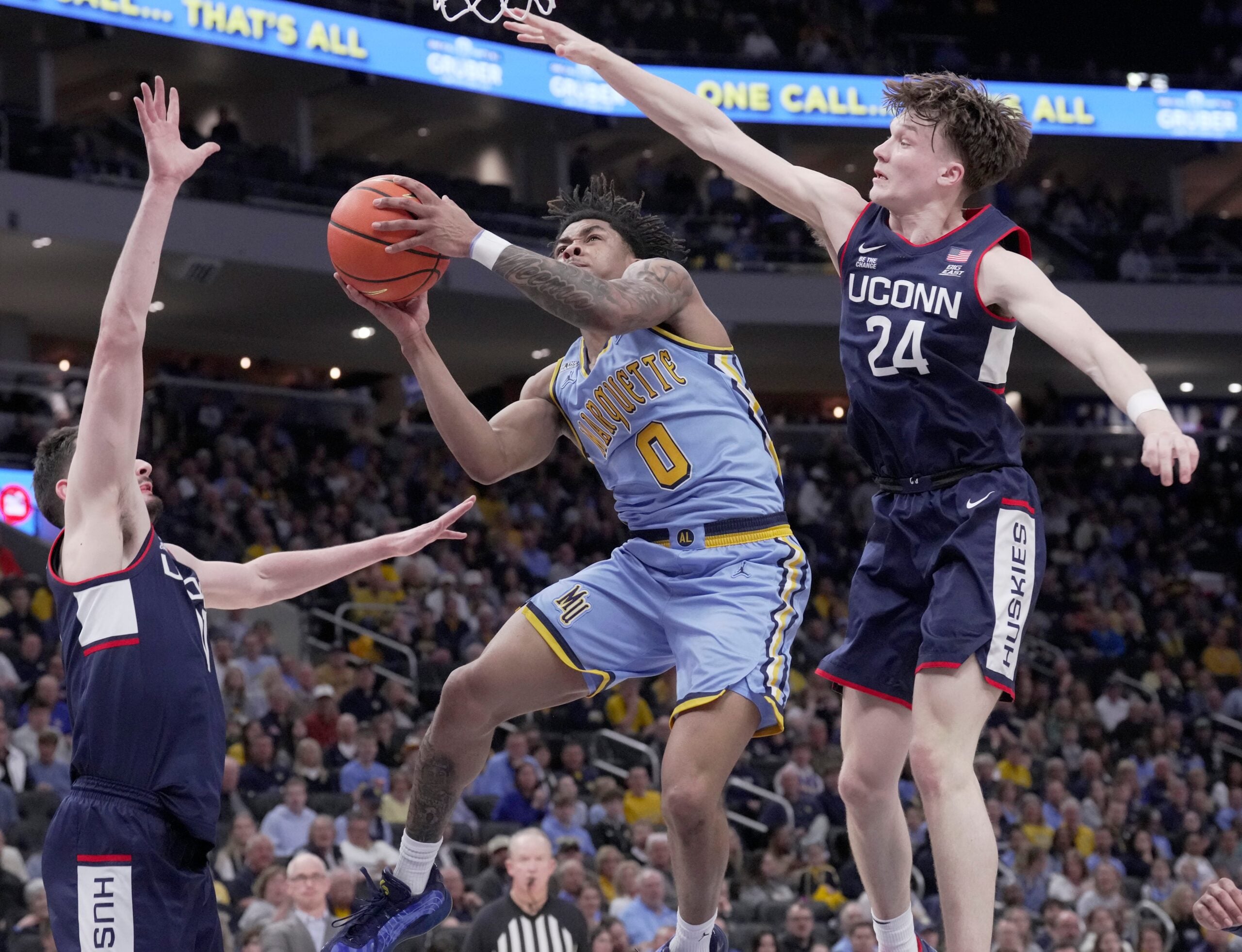 Marquette guard Nigel James Jr. (0) tries to score on UConn guard Braylon Mullins (24) during the first half of their game Saturday, March 7, 2026 at Fiserv Forum in Milwaukee, Wisconsin.