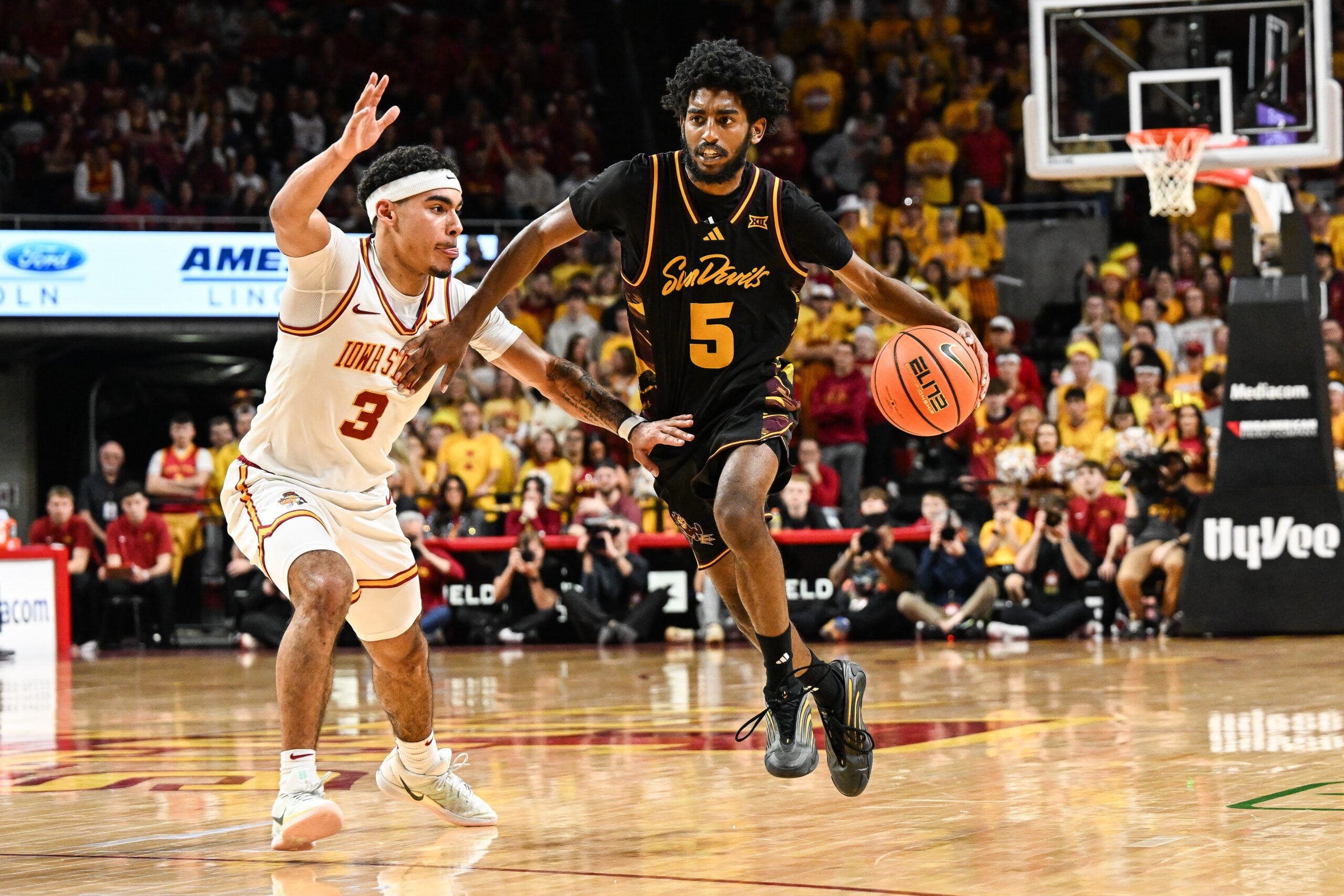 Mar 7, 2026; Ames, Iowa, USA; Arizona State Sun Devils guard Maurice Odum (5) is defended by Iowa State Cyclones guard Tamin Lipsey (3) during the second half at James H. Hilton Coliseum. Mandatory Credit: Jeffrey Becker-Imagn Images