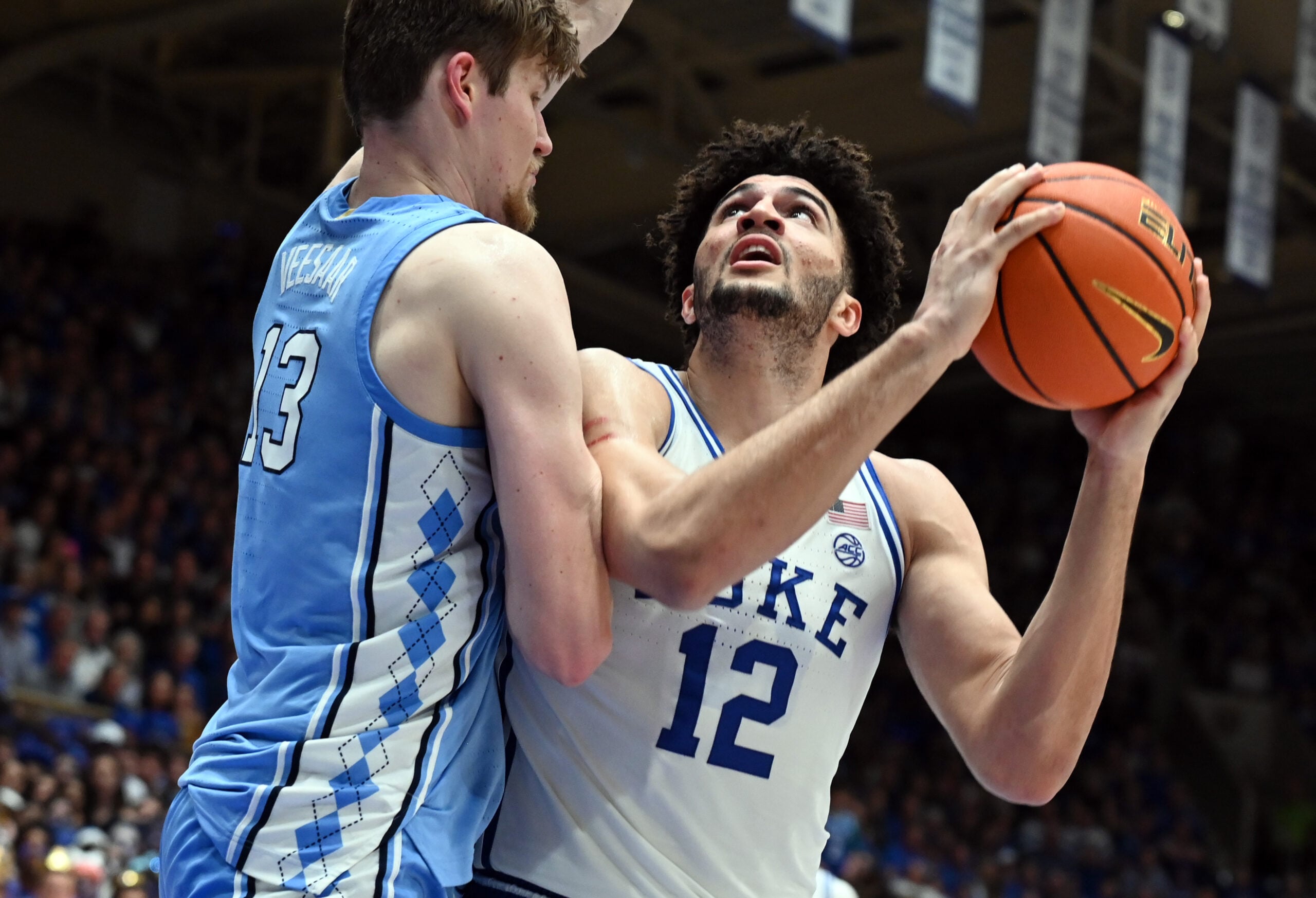 Mar 7, 2026; Durham, North Carolina, USA; Duke Blue Devils forward Cameron Boozer (12) looks to shoot as North Carolina Tar Heels center Henri Veesaar (13) defends during the second half at Cameron Indoor Stadium.  The Duke Blue Devils won 76-61. Mandatory Credit: Rob Kinnan-Imagn Images