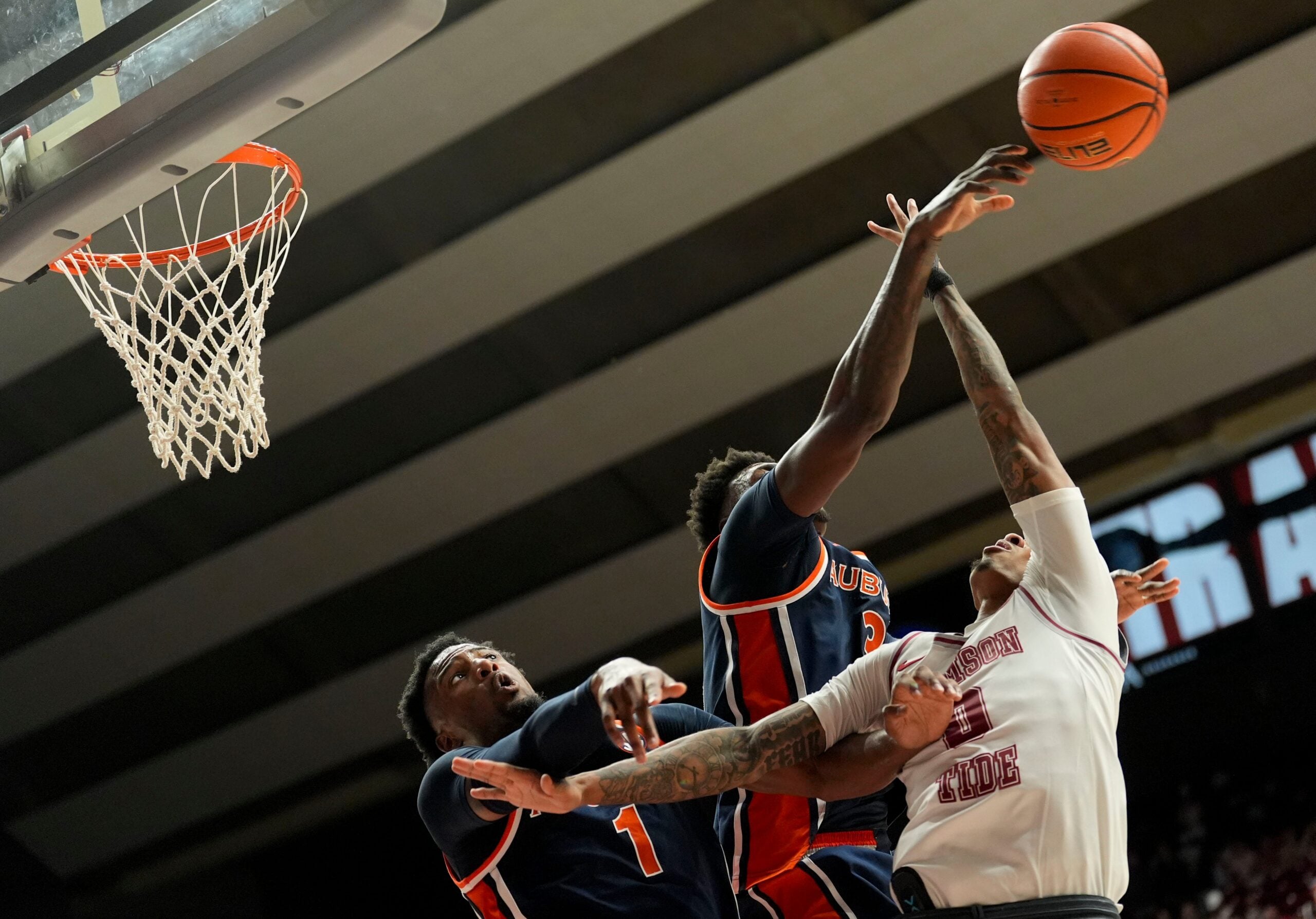 Mar 7, 2026; Tuscaloosa, AL, USA; Auburn guard Kevin Overton (1) fouls Alabama guard Labaron Philon Jr. (0) as Philon’s shot is blocked by Auburn forward Keshawn Murphy (3) at Coleman Coliseum. Alabama defeated Auburn 96-84. Mandatory Credit: Gary Cosby Jr.-Tuscaloosa News