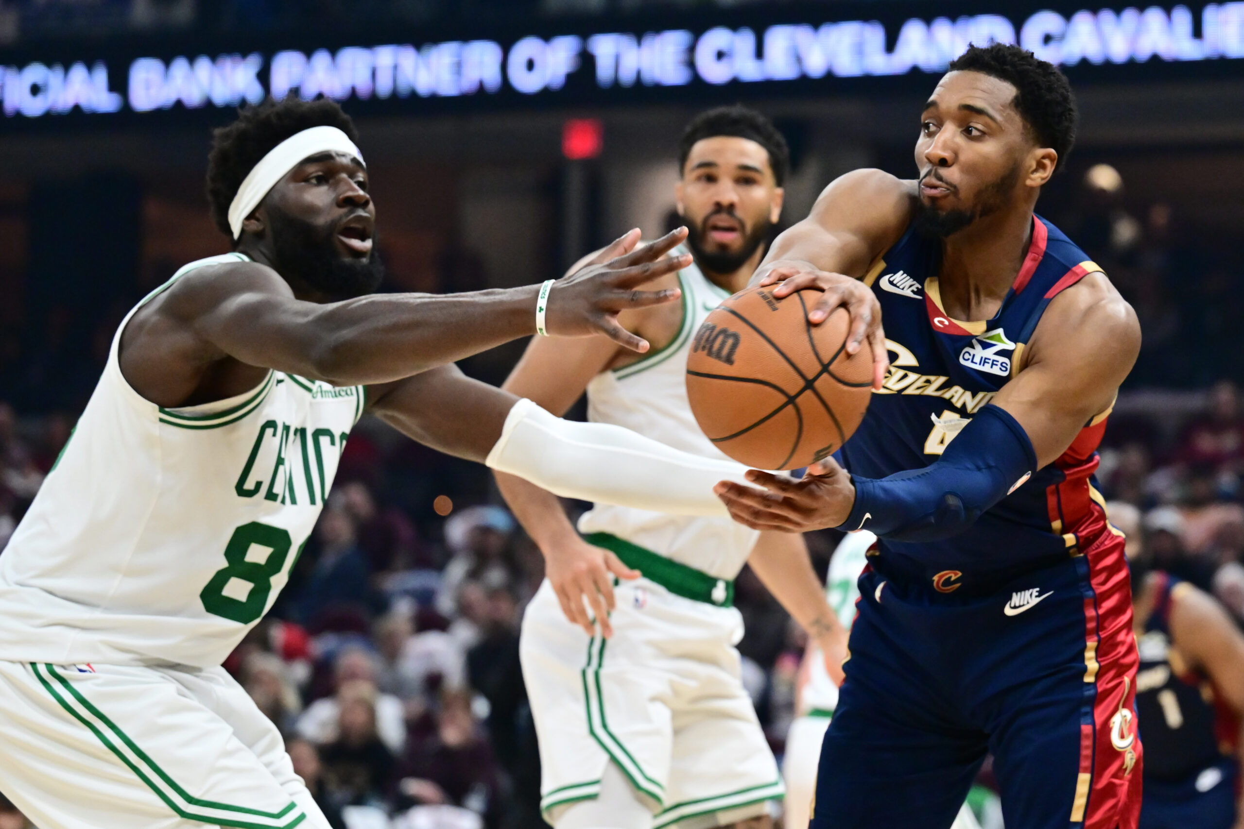 Mar 8, 2026; Cleveland, Ohio, USA; Cleveland Cavaliers guard Donovan Mitchell (45) passes as Boston Celtics center Neemias Queta (88) defends during the second half at Rocket Arena. Mandatory Credit: Ken Blaze-Imagn Images