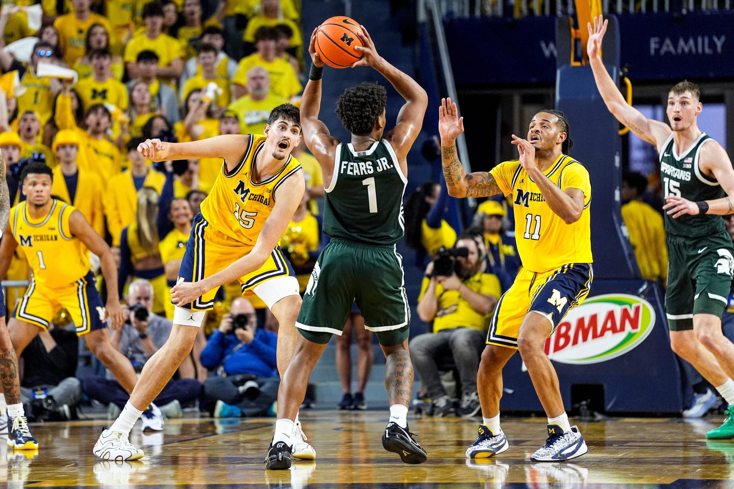 Michigan center Aday Mara (15) and guard Roddy Gayle Jr. (11) defend Michigan State guard Jeremy Fears Jr. (1) during the second half at Crisler Center in Ann Arbor on Sunday, March 8, 2026.
