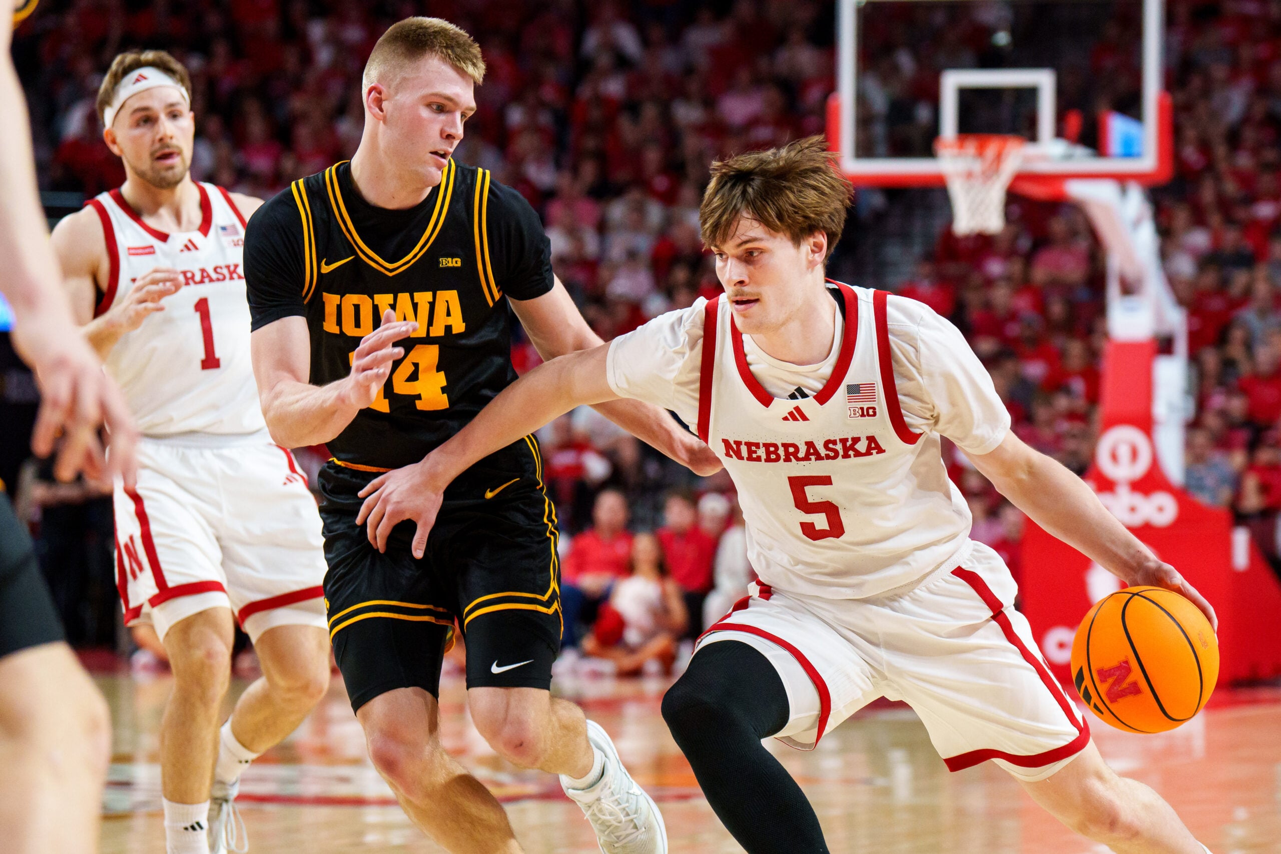 Mar 8, 2026; Lincoln, Nebraska, USA; Nebraska Cornhuskers forward Braden Frager (5) drives against Iowa Hawkeyes guard Bennett Stirtz (14) during the first half at Pinnacle Bank Arena. Mandatory Credit: Dylan Widger-Imagn Images