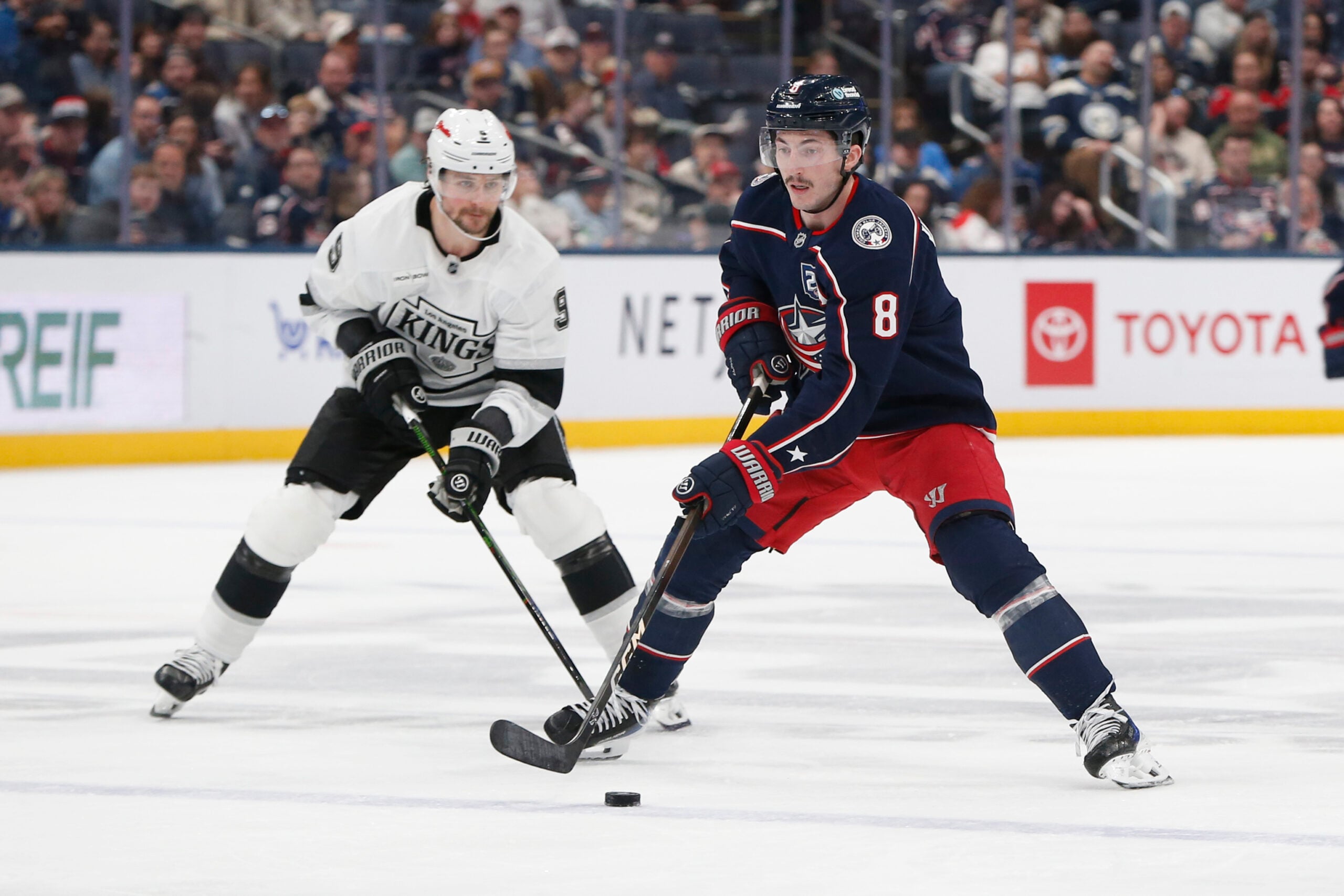 Mar 9, 2026; Columbus, Ohio, USA; Columbus Blue Jackets defenseman Zach Werenski (8) controls the puck as Los Angeles Kings right wing Adrian Kempe (9) trails the play during the second period at Nationwide Arena. Mandatory Credit: Russell LaBounty-Imagn Images