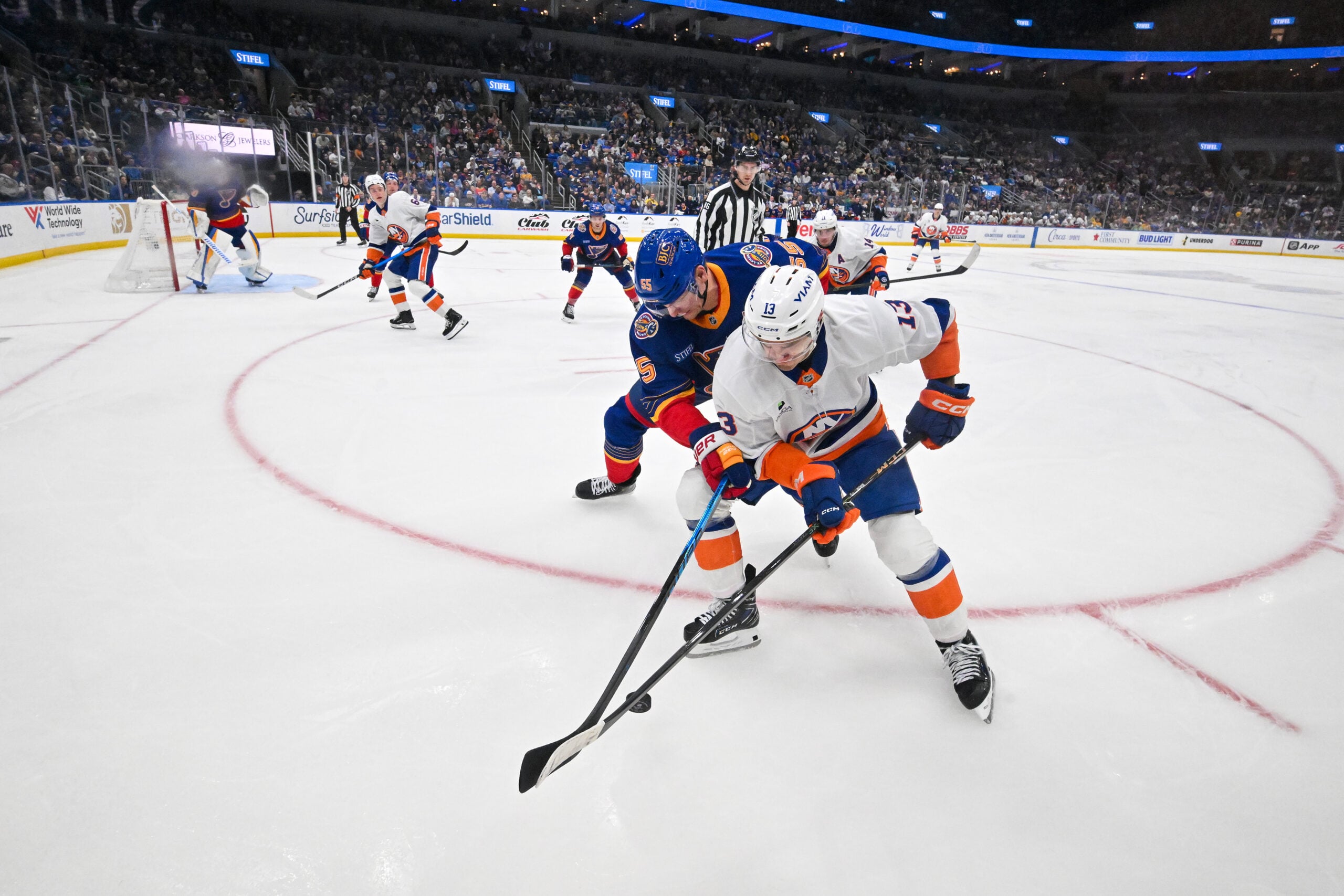 Mar 10, 2026; St. Louis, Missouri, USA; New York Islanders center Mathew Barzal (13) and St. Louis Blues defenseman Colton Parayko (55) battle for the puck during the third period at Enterprise Center. Mandatory Credit: Jeff Curry-Imagn Images