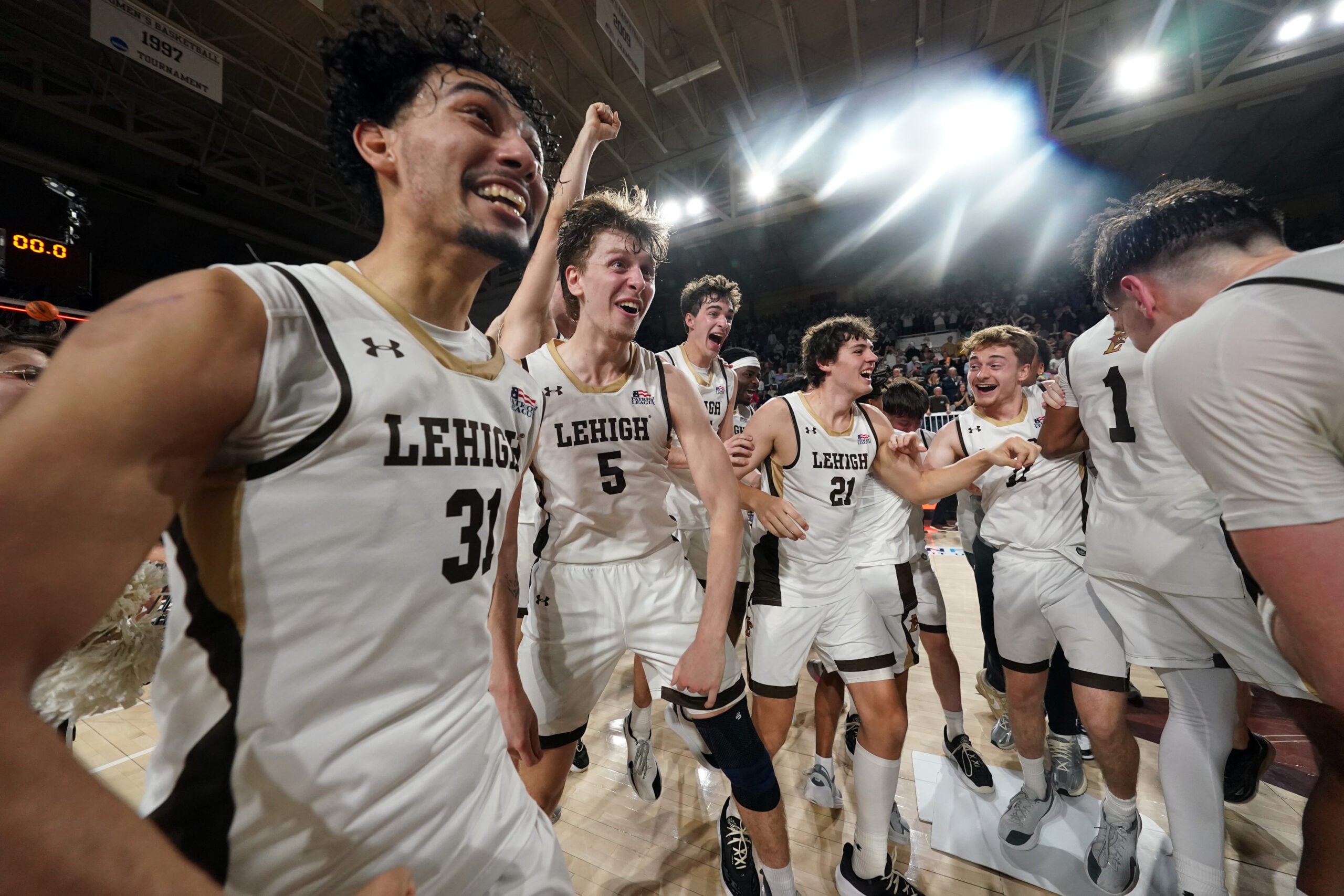 Mar 11, 2026; Bethlehem, Pennsylvania, USA; Lehigh Mountain Hawks forward Edouard Benoit (5) and Lehigh Mountain Hawks guard Jalen Vazquez (31) react after defeating the Boston University Terriers in the Patriot League Championship at Stabler Arena. Mandatory Credit: James Lang-Imagn Images